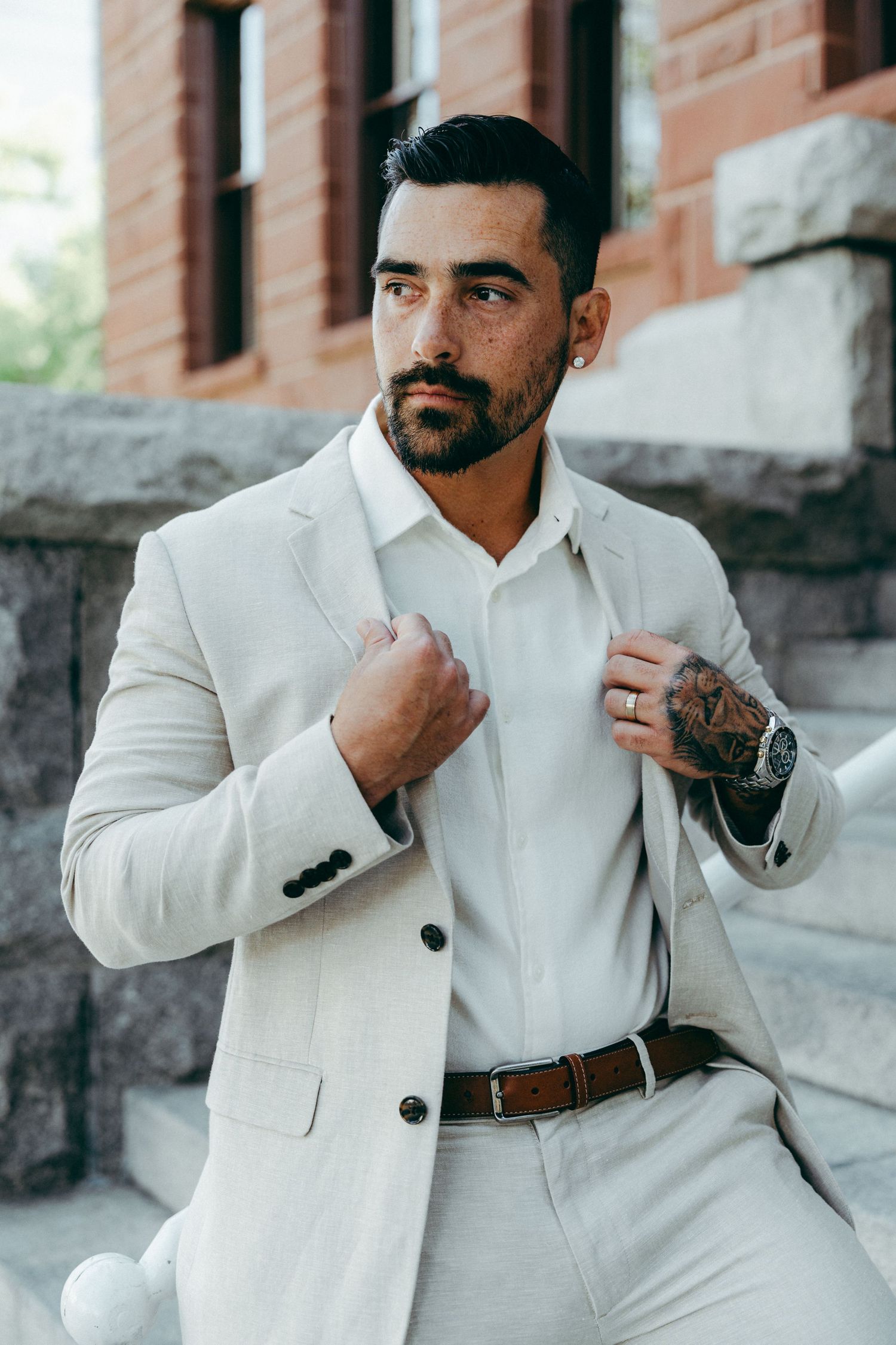 A crisp white suit and dress shirt combination styled for a formal occasion.