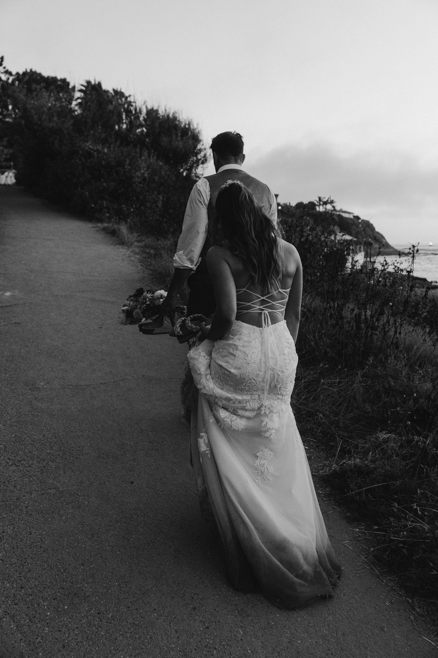 Black and white wedding photos showing couple dancing in an outdoor setting at sunset.