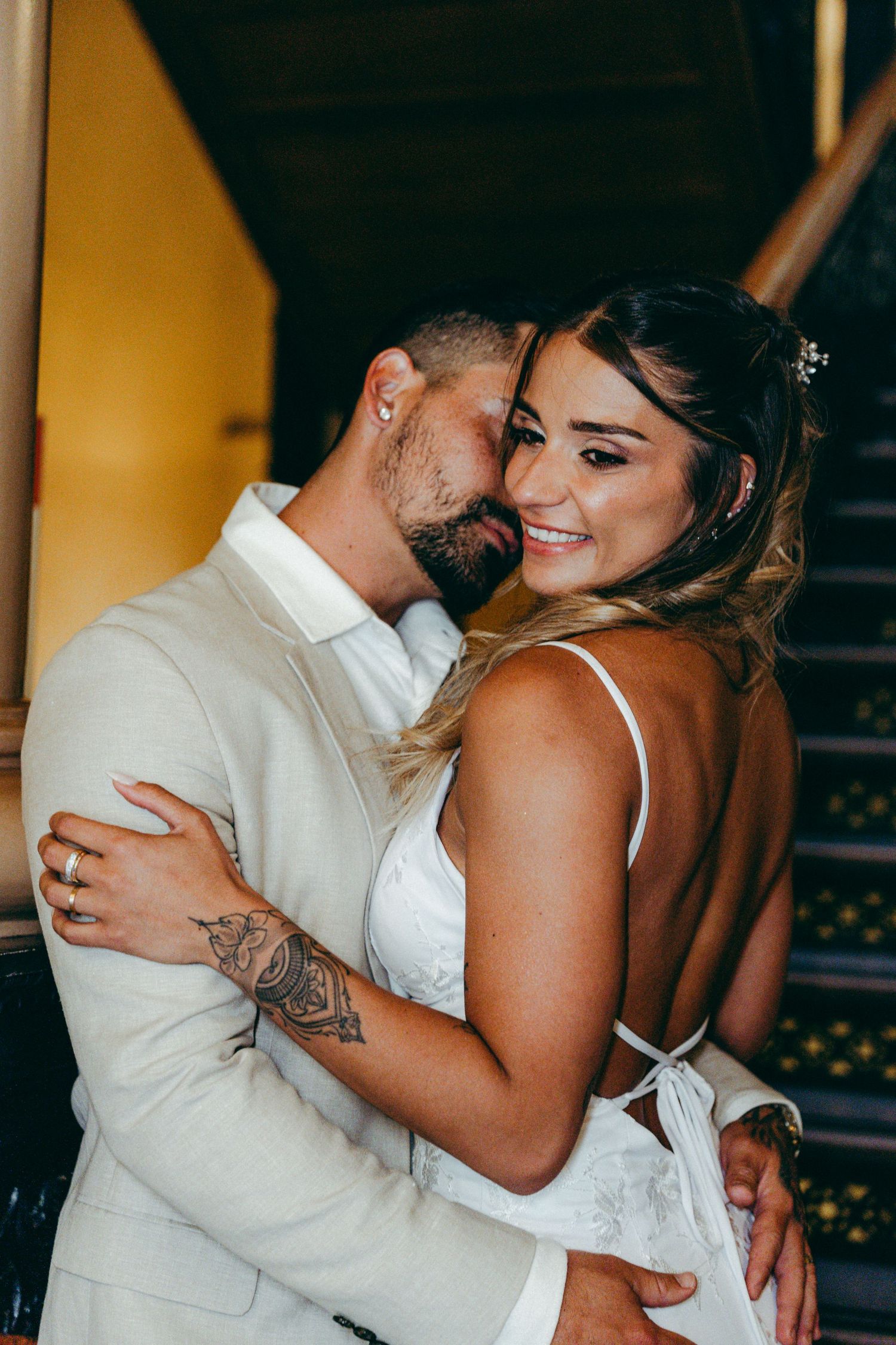 A romantic embrace between newlyweds during their wedding photoshoot.