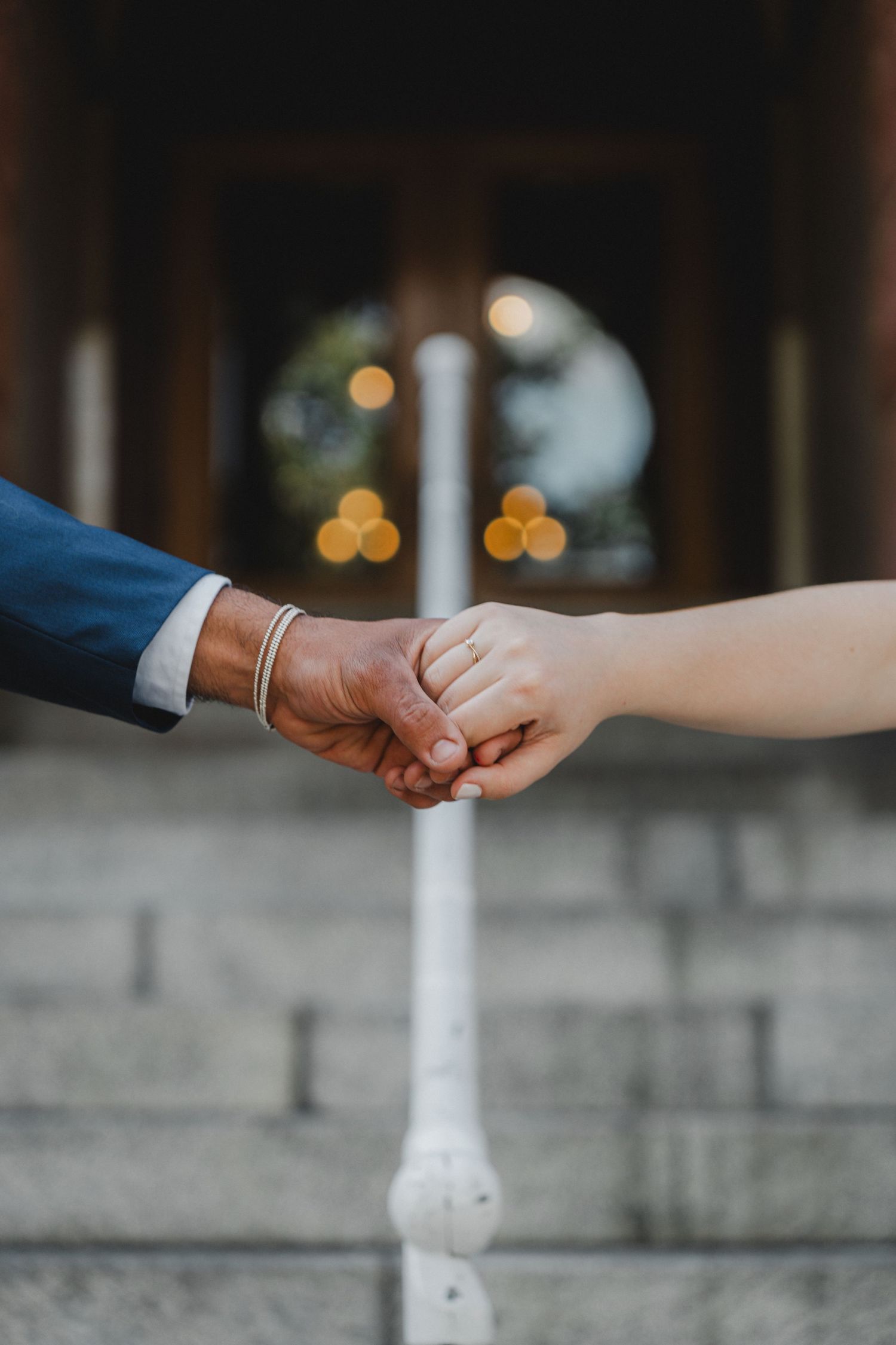 Close-up sequence of hands exchanging rings during a wedding ceremony.