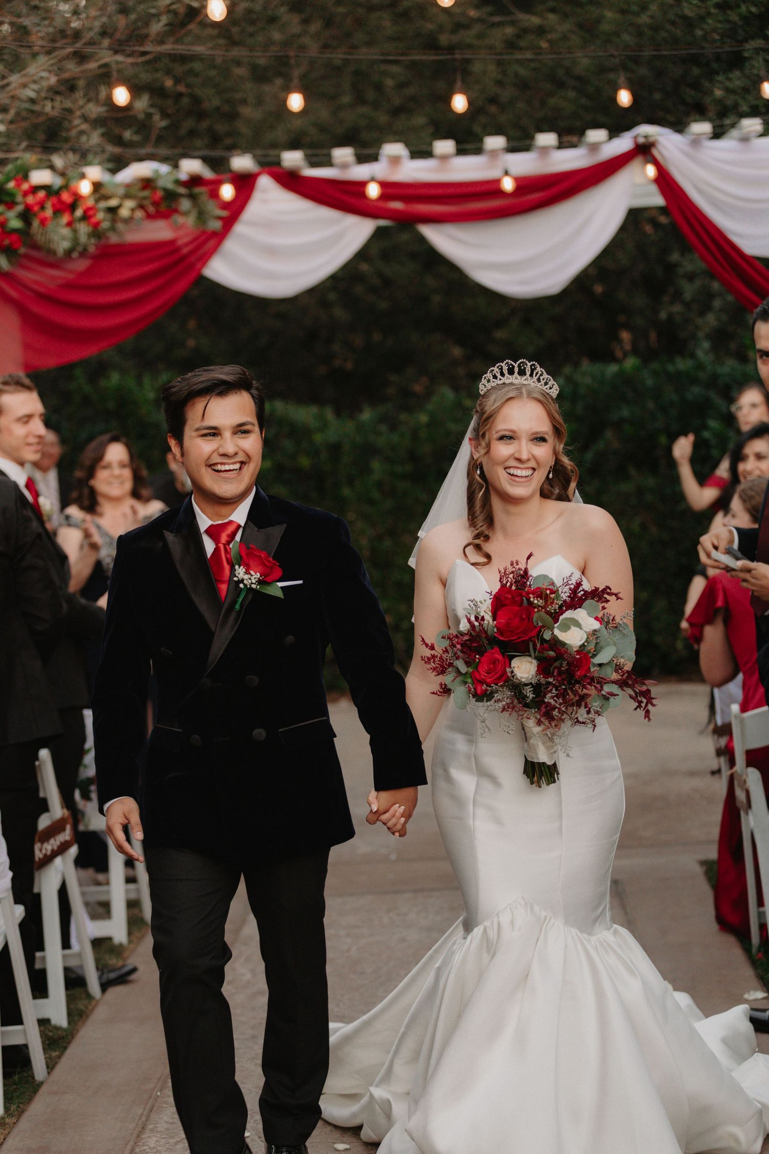 Joyful wedding ceremony moments captured in a series of photos showing the couple walking down the aisle with red decor.