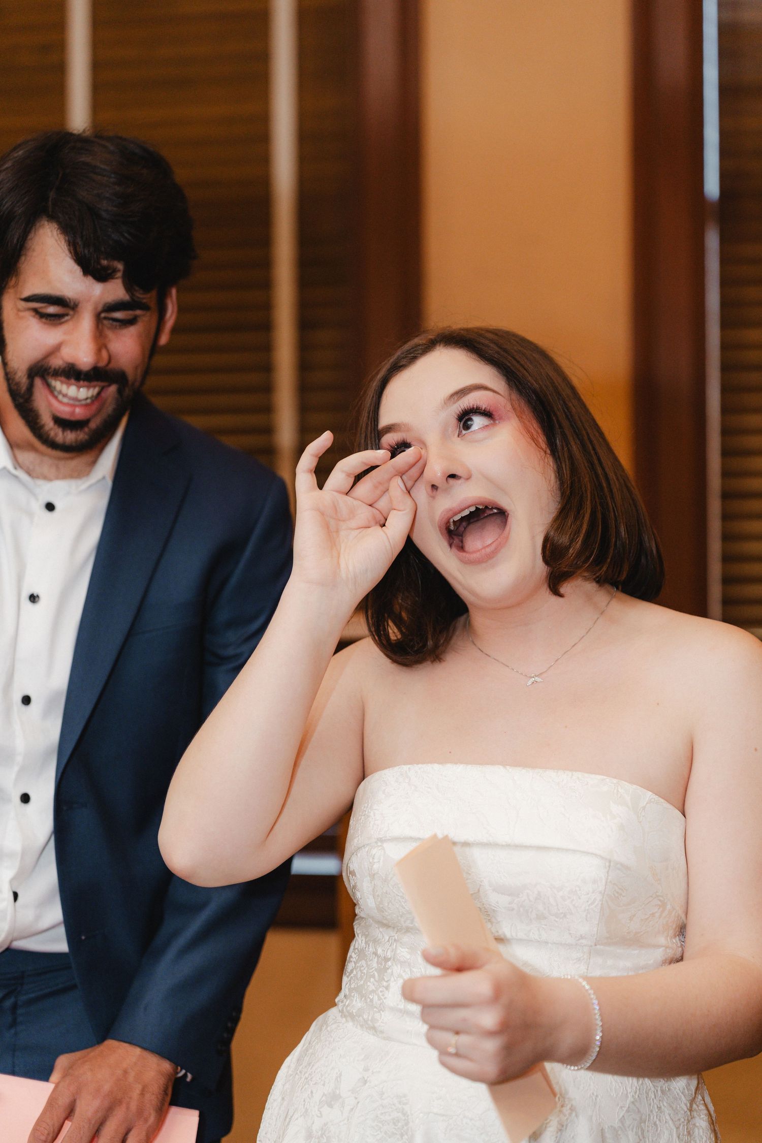 Candid moments of joy and laughter captured during wedding preparations.