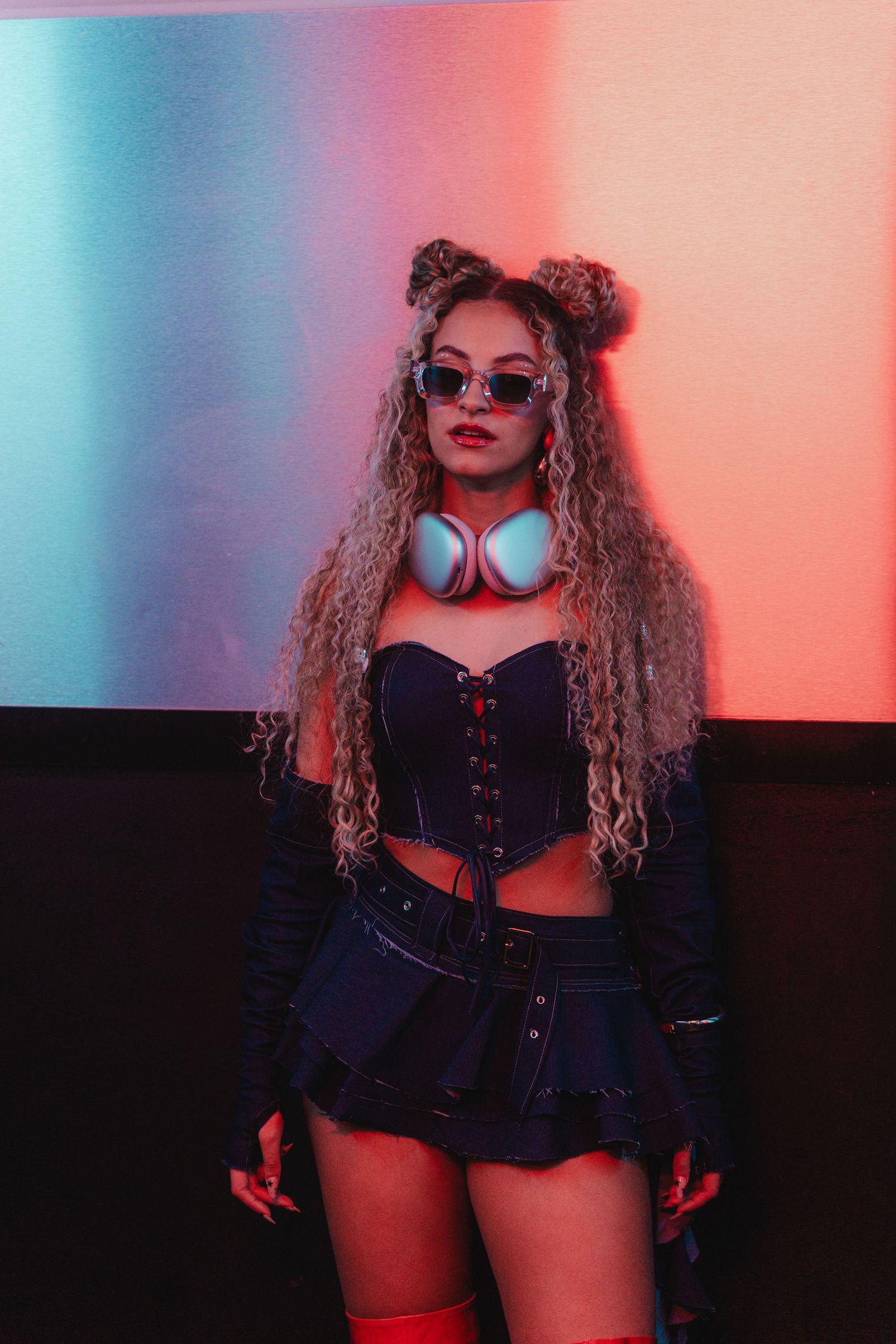 Stylish portrait with neon lighting and retro fashion elements.