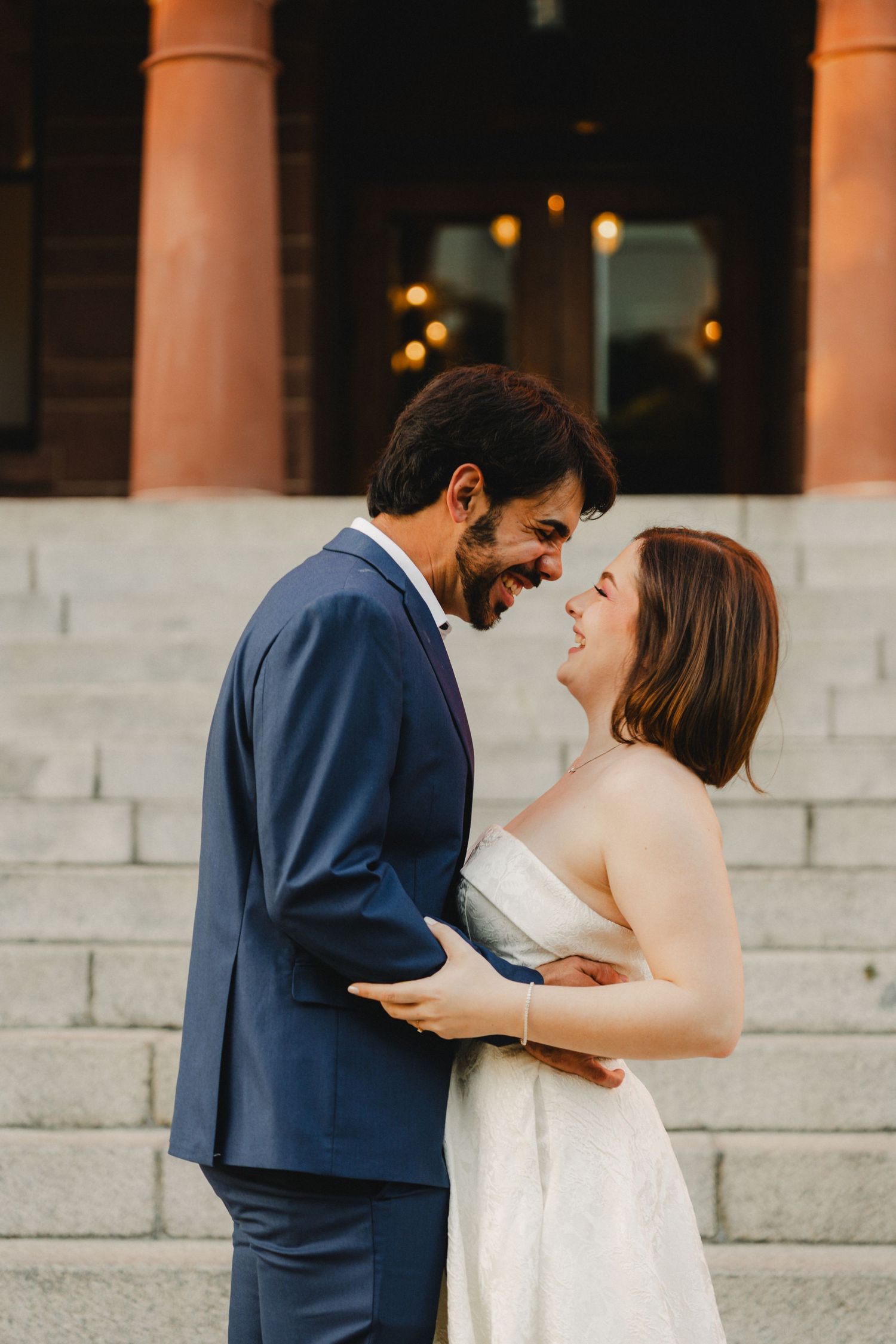 Couple shares tender moments during their wedding photoshoot on stone steps.