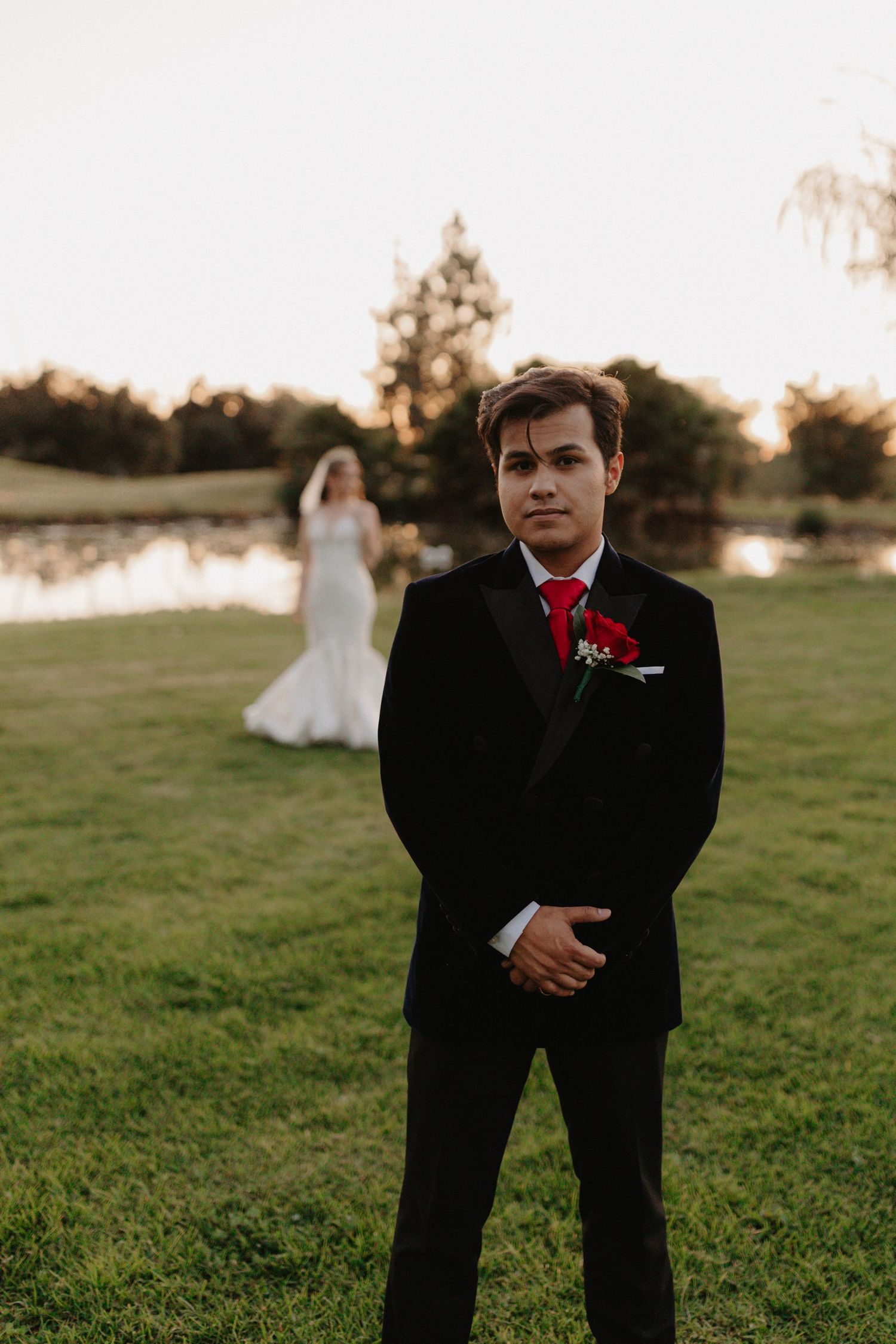 A series of candid wedding photos showing a couple in formal attire on a grassy field at sunset.