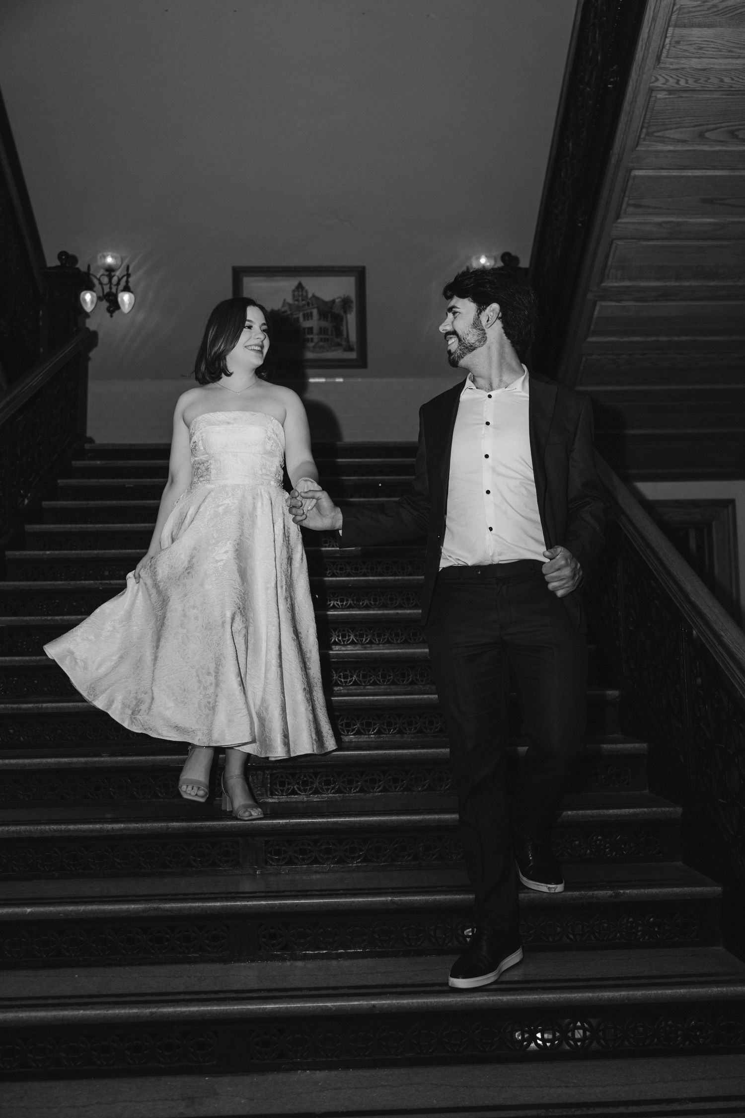 Black and white photos of a couple walking up vintage stairs in formal attire.