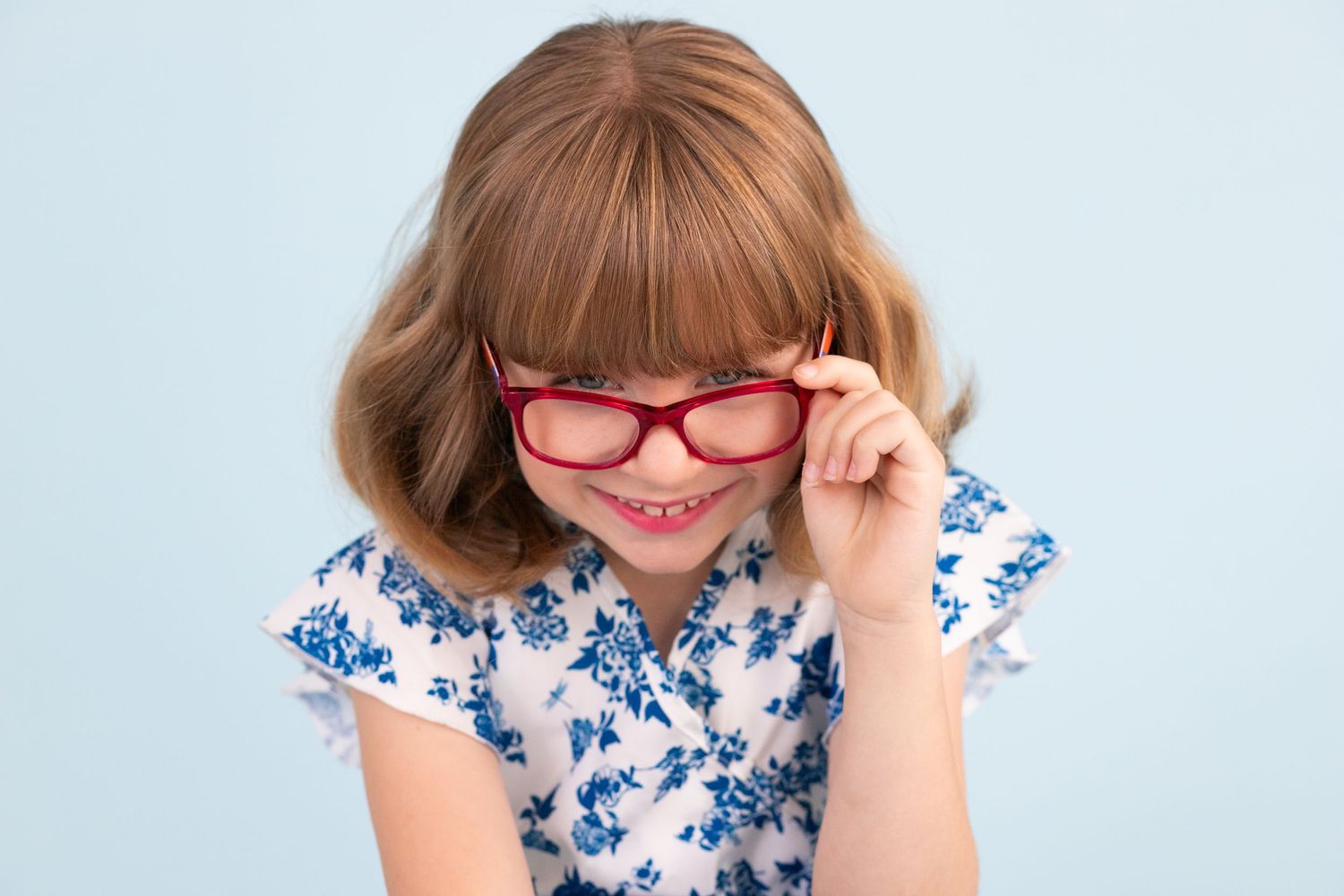 Portrait session against light blue background.