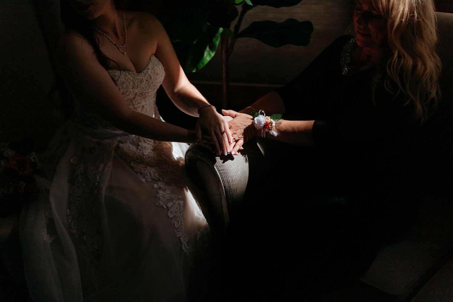 Dramatic low-key lighting illuminates hands and objects in darkness.