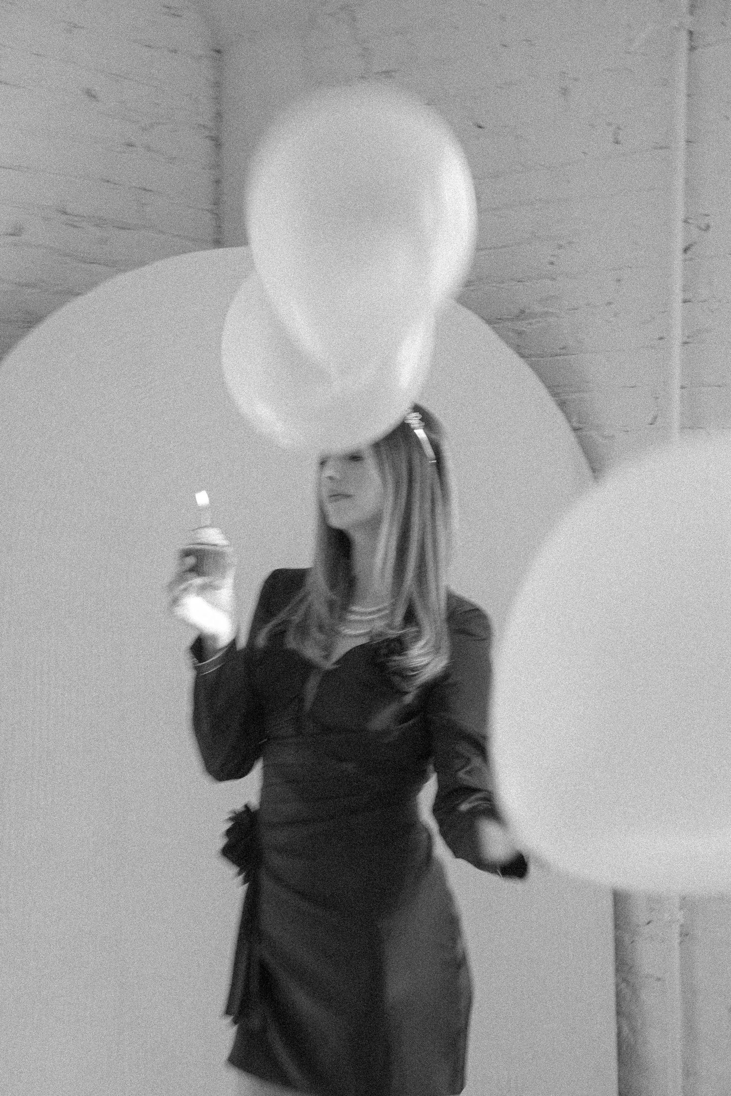 Artistic black and white sequence showing white balloons against a light background.