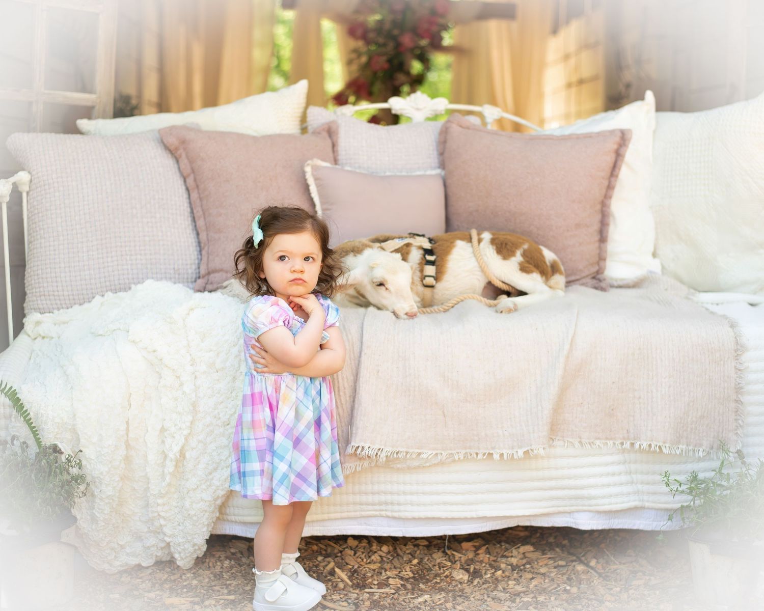 Dreamy white daybed setup with soft pillows and vintage decor.