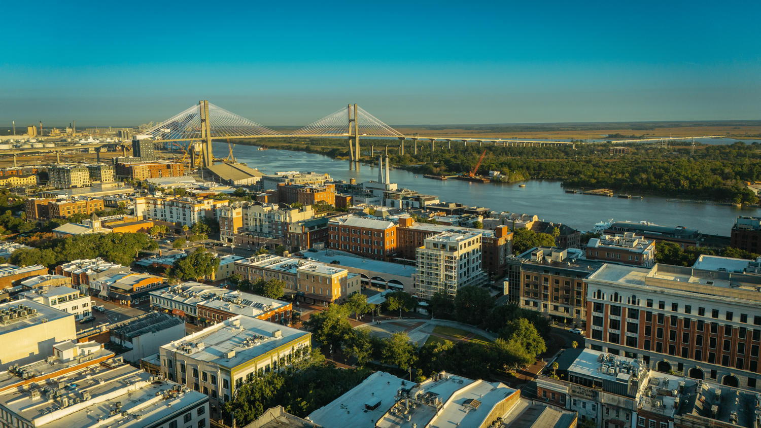Aerial panoramic view of Charleston South Carolina skyline with Cooper River Bridge and historic buildings.