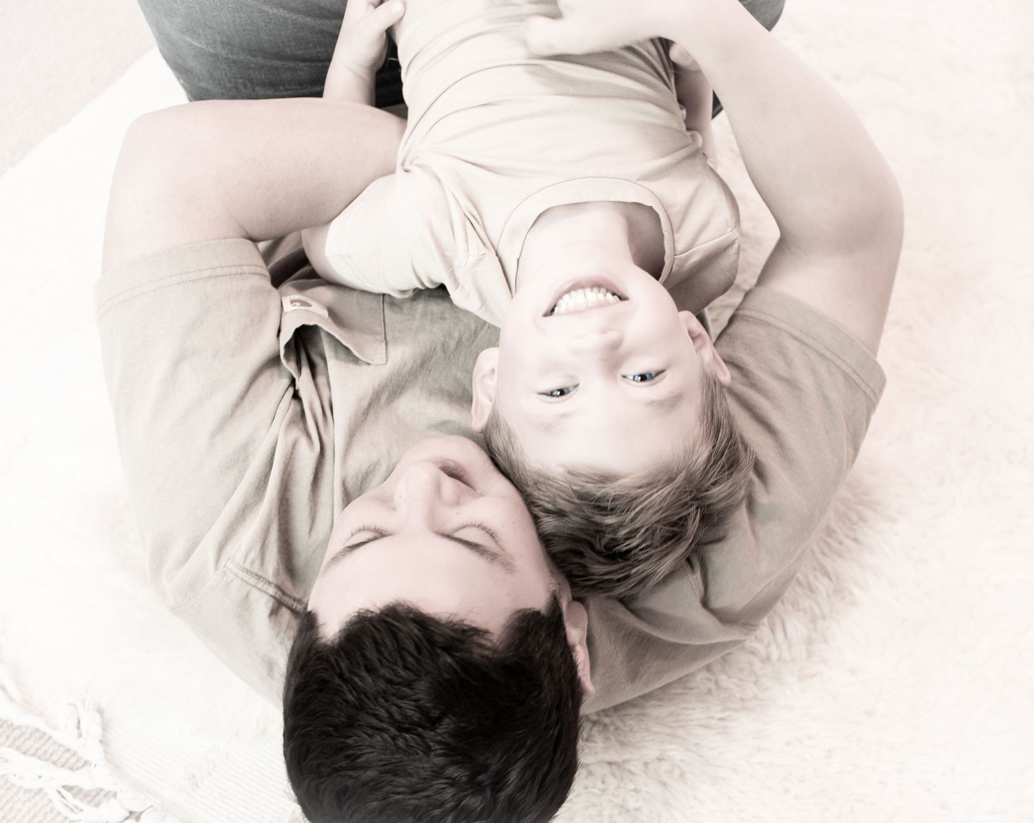 A series of artistic black and white portraits showing people lying down with their eyes closed in a peaceful pose.