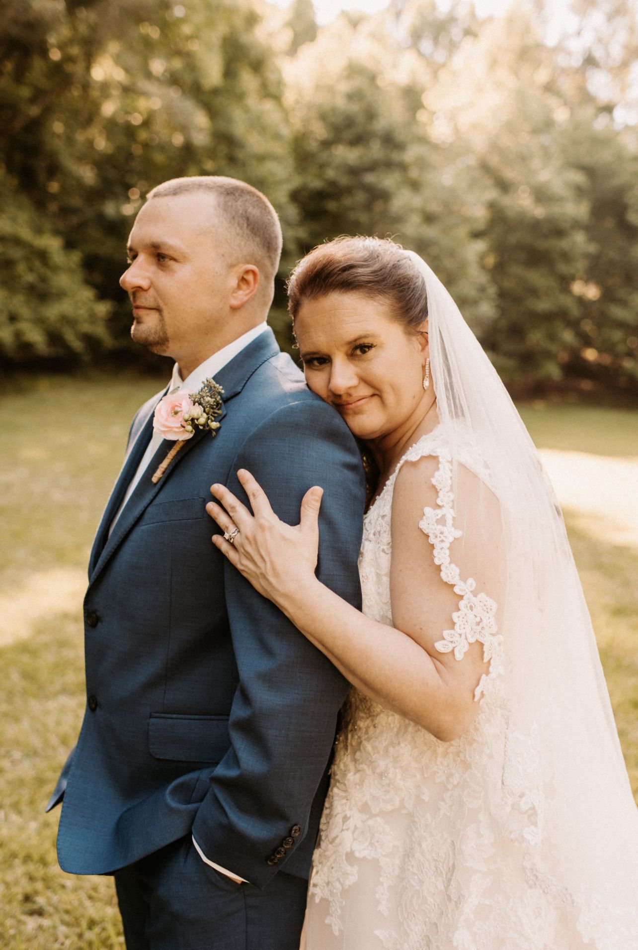 A tender wedding moment captured in an intimate outdoor setting.