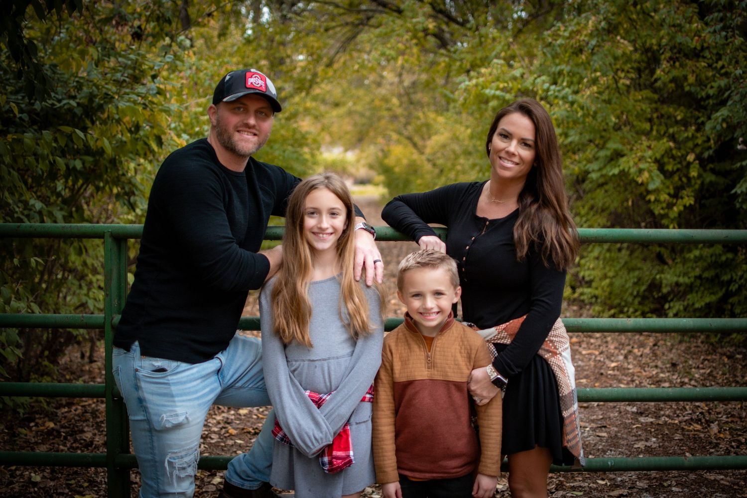 Family portrait session at a rustic outdoor location during golden hour.