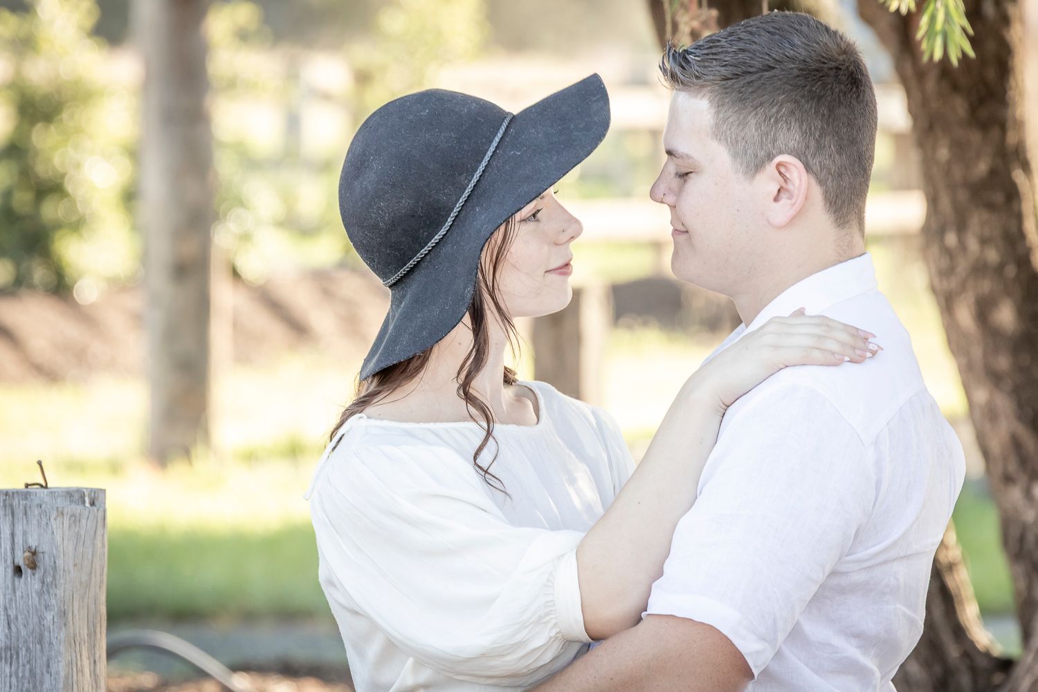A black and white romantic photo sequence shows a couple embracing outdoors in a park setting.