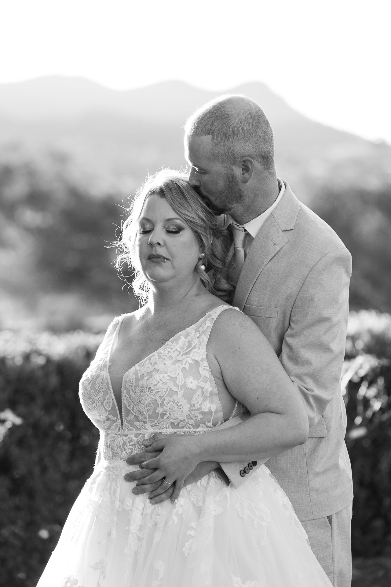 A romantic black and white photo sequence shows a couple in wedding attire sharing intimate moments outdoors.