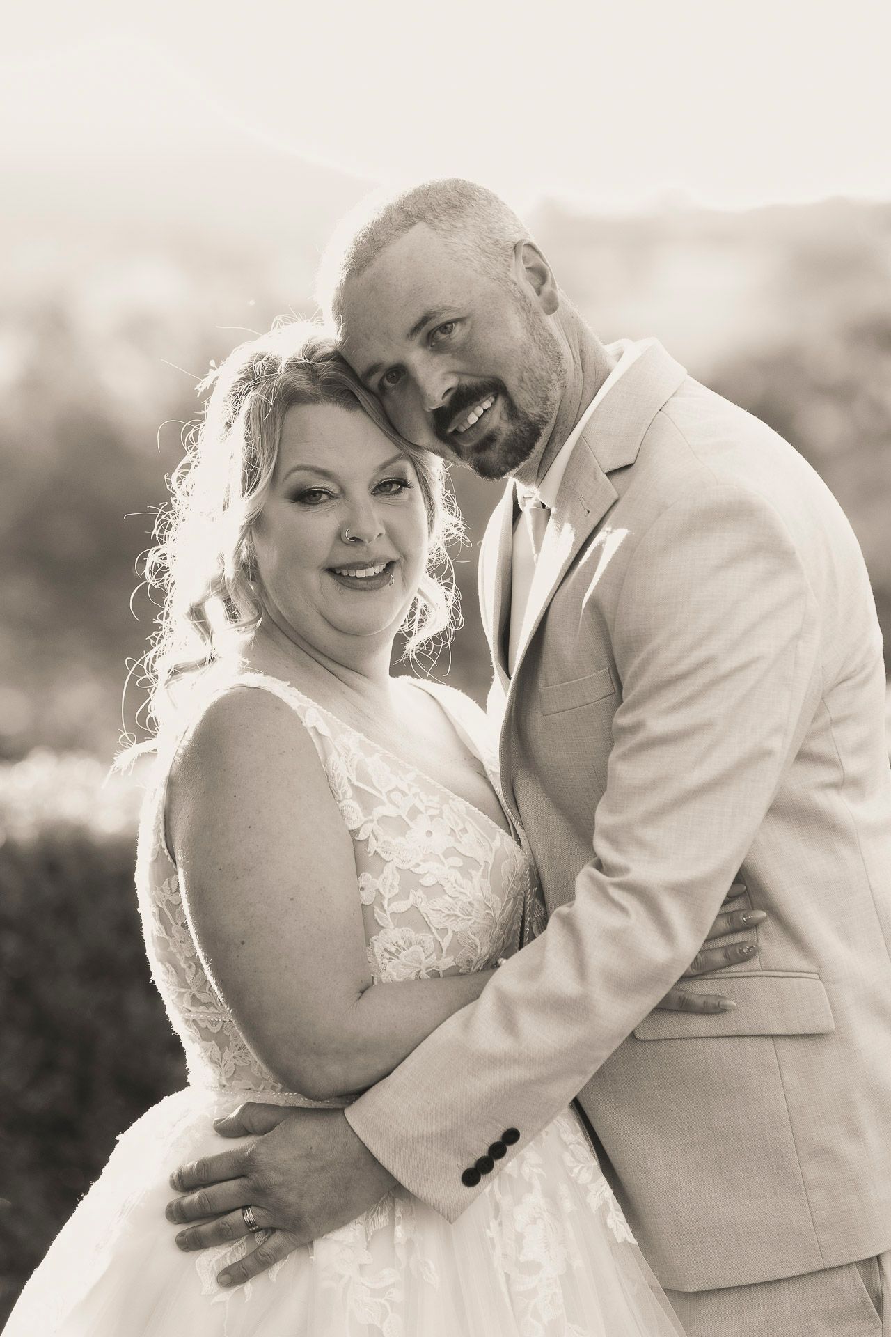 A romantic series of black and white wedding photos showing tender moments between a bride and groom in outdoor settings.