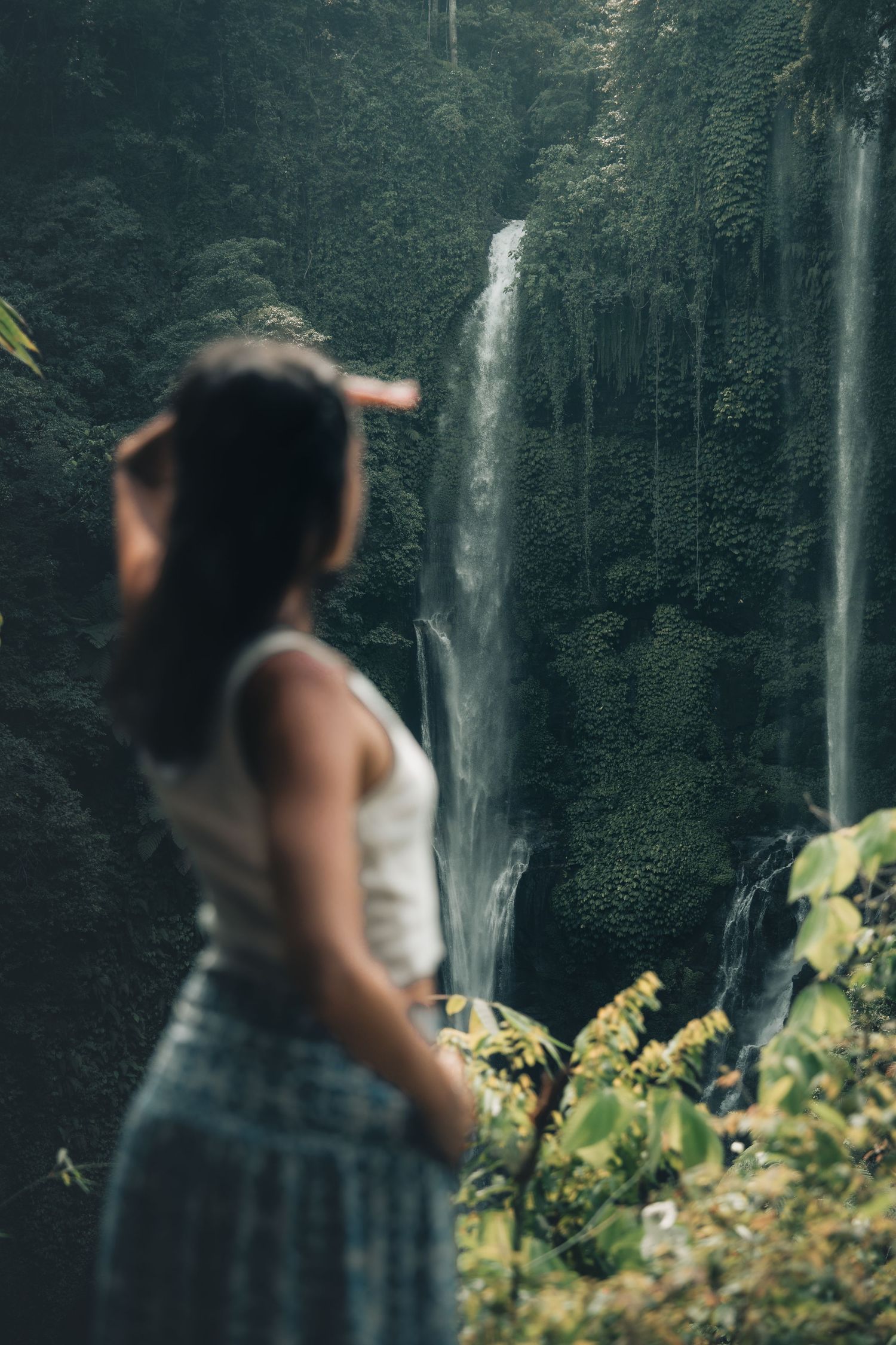 Scenic waterfall viewpoint in tropical forest setting with dramatic cliff walls.