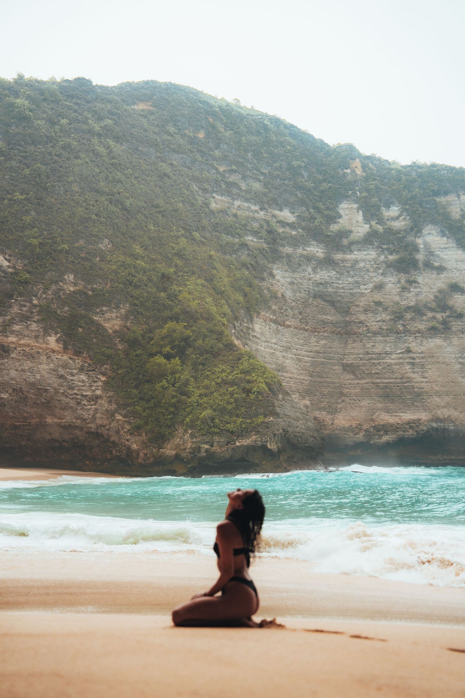 Secluded beach cove with turquoise waters surrounded by dramatic limestone cliffs.