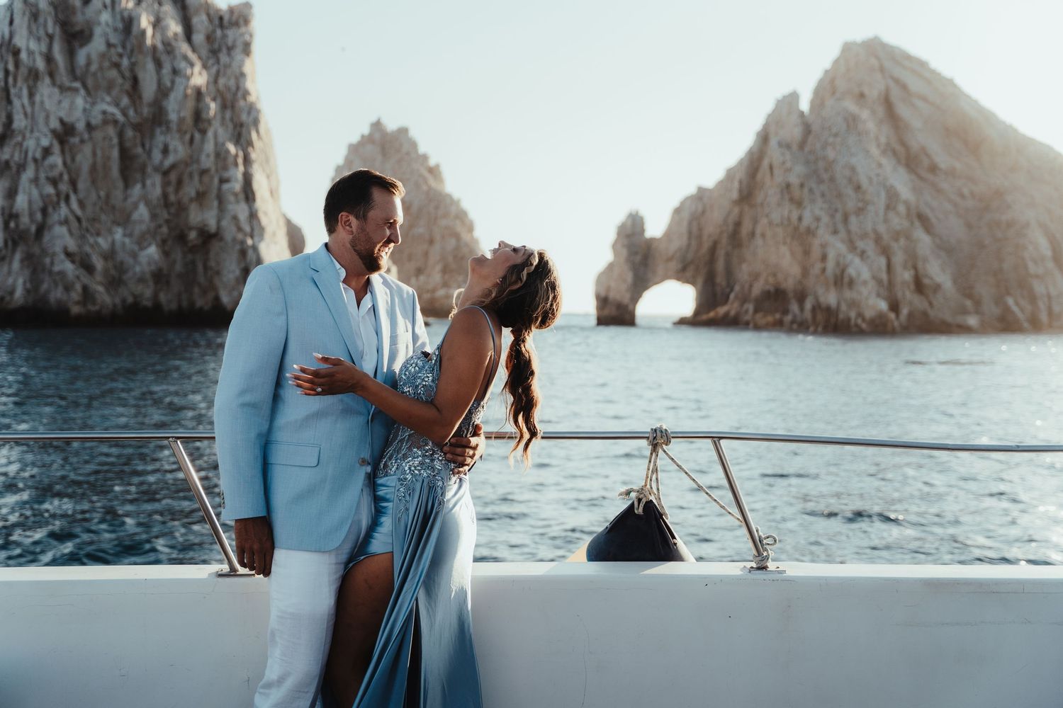 Romantic coastal photography session with rocky cliffs and ocean waves in Los Cabos.
