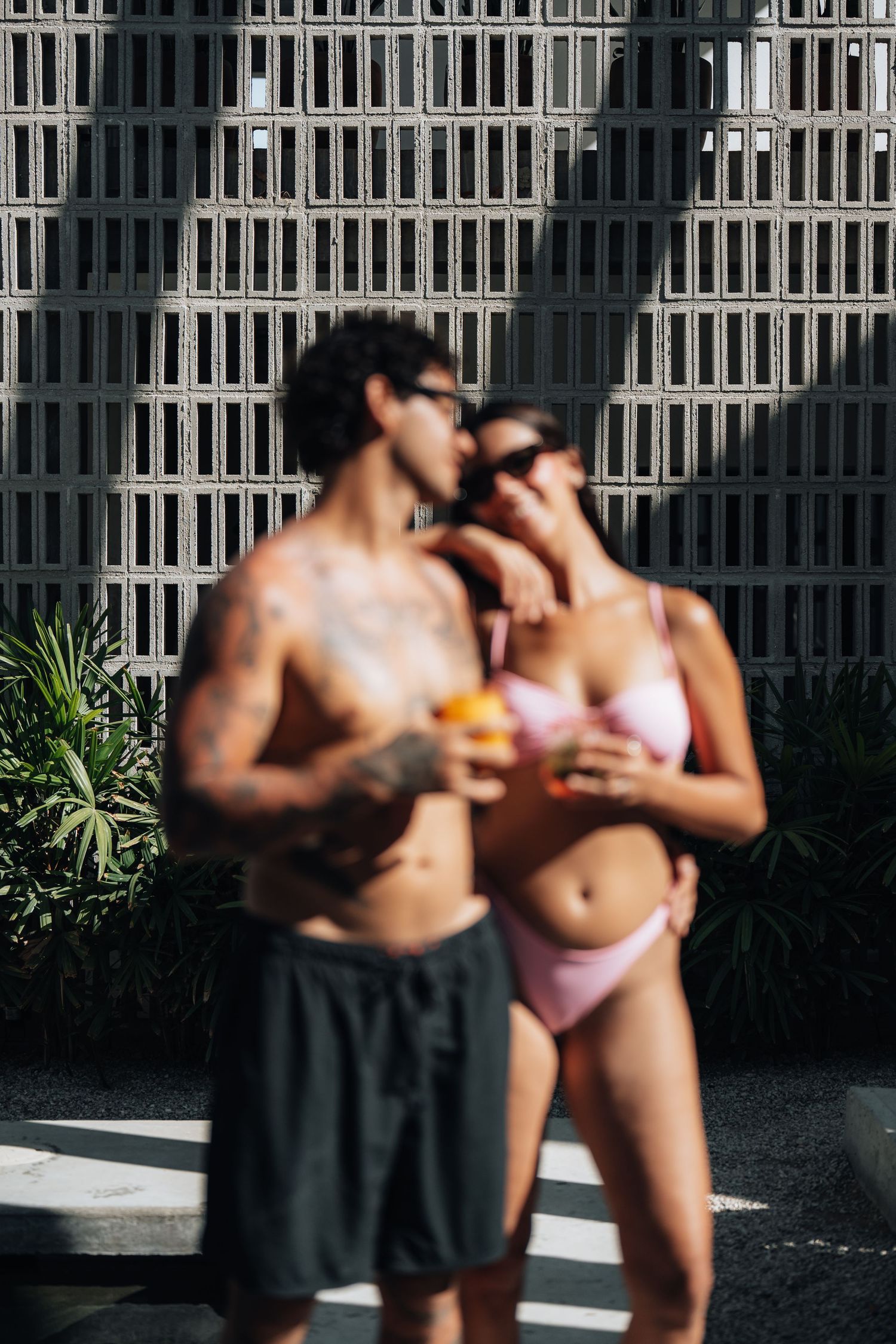 A sequence of intimate beachside moments with palm trees and bright sunlight.