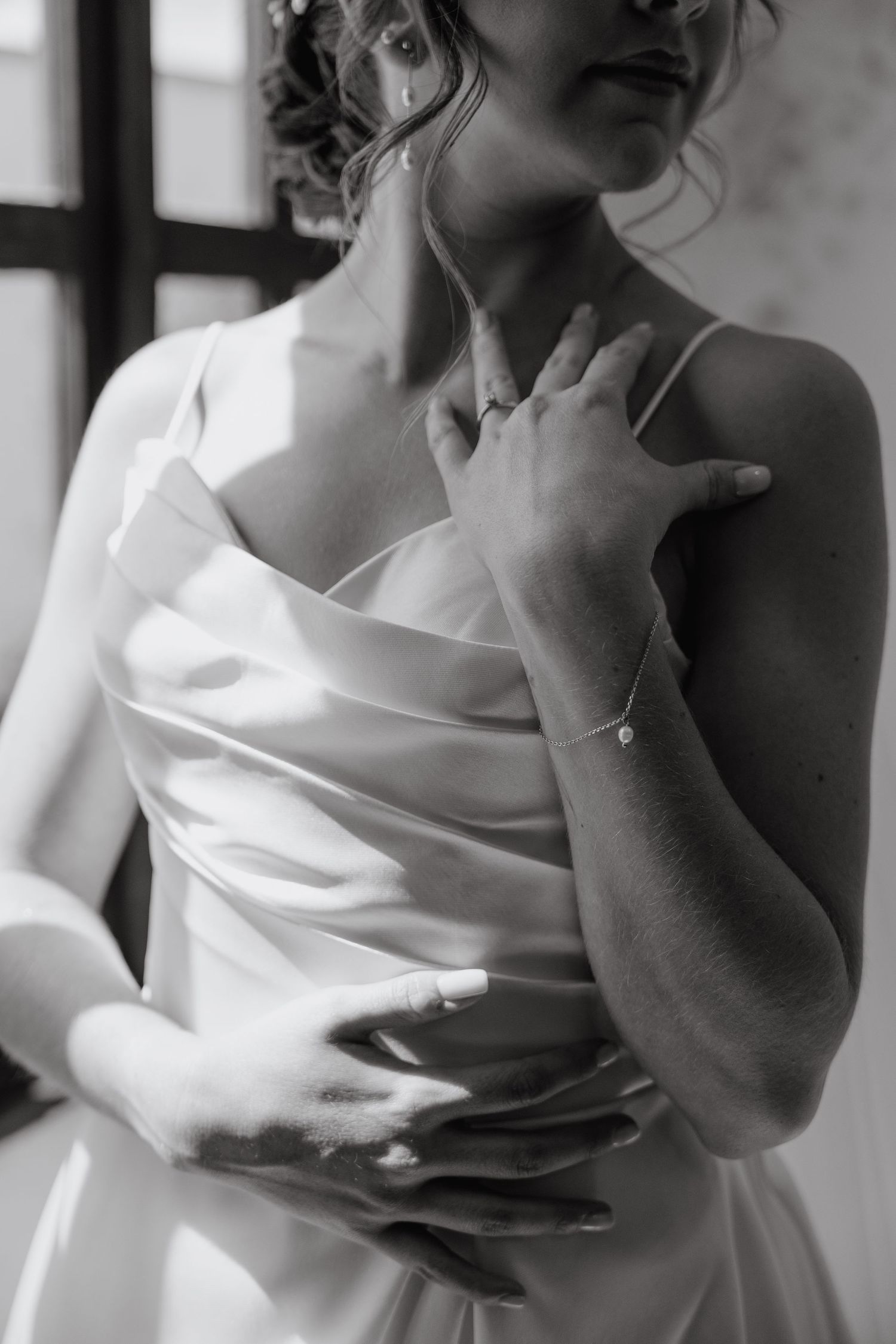 Artistic black and white portrait shots highlighting elegant white wedding dress details.