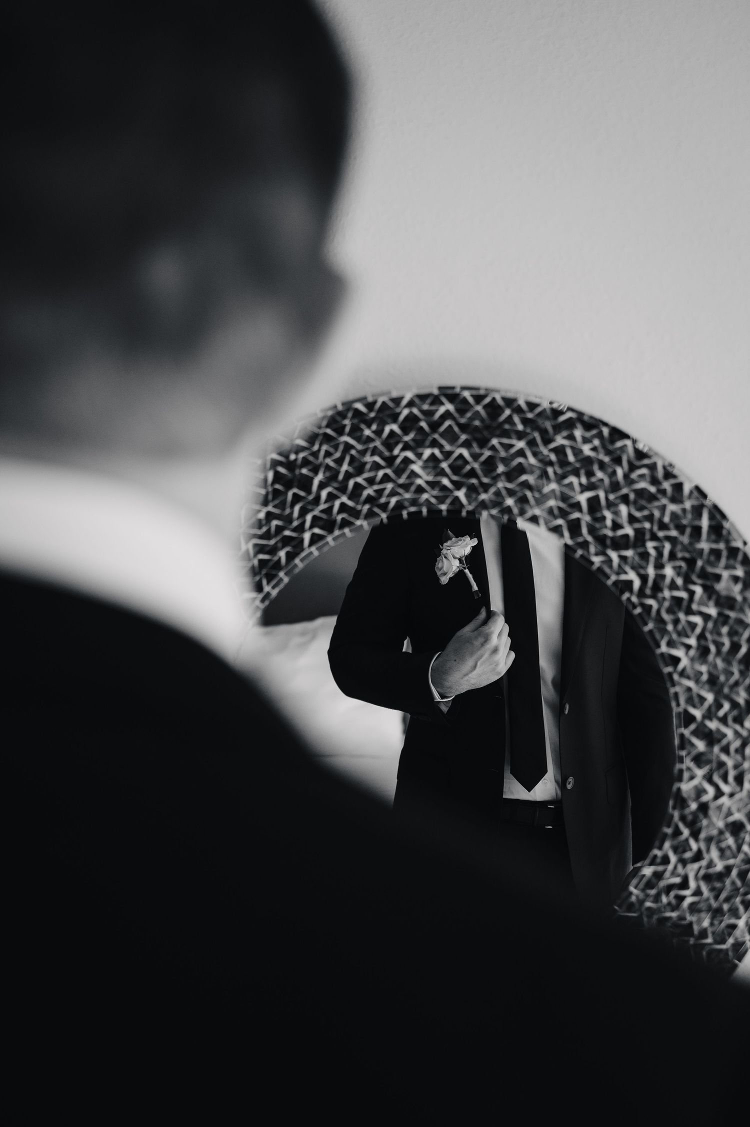 Abstract black and white silhouettes creating geometric patterns against a light background.