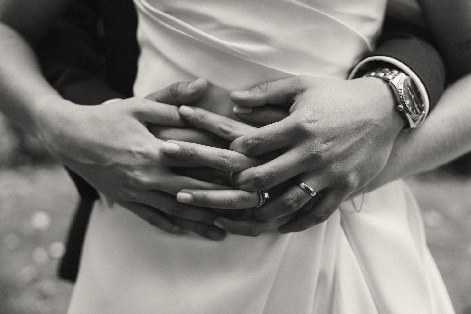 Close-up view of hands gently cradling objects in a series of black and white photographs.