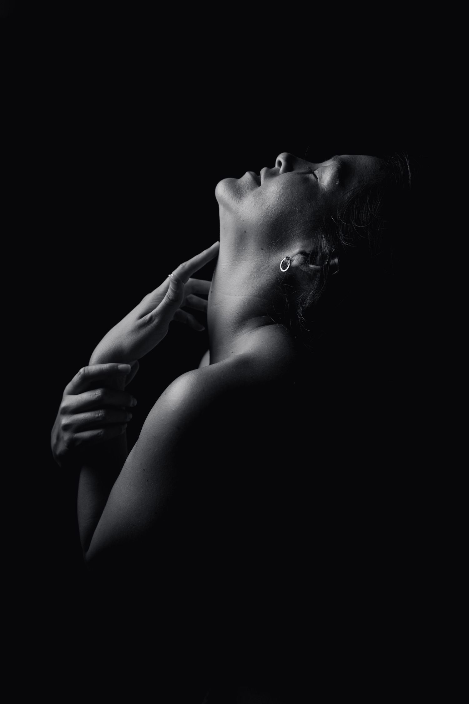 Black and white portrait study showing dramatic shadows and highlights.
