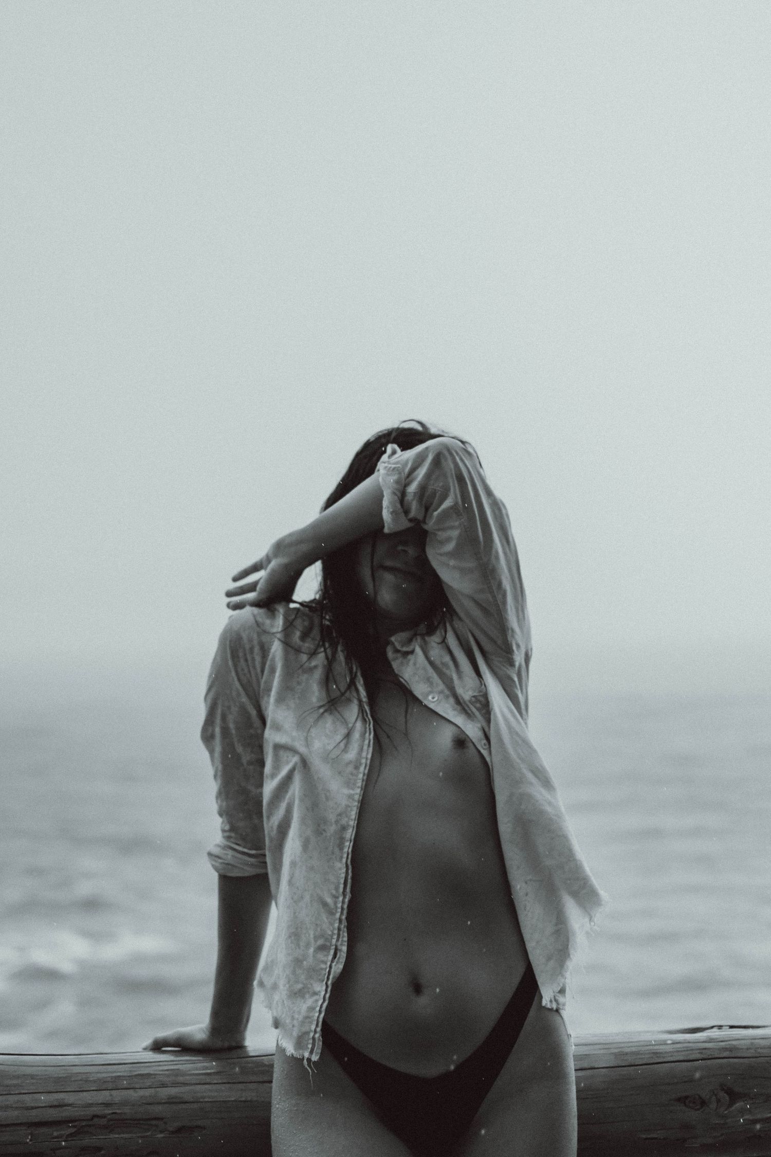 Minimalist black and white beach fashion photography with muted tones.