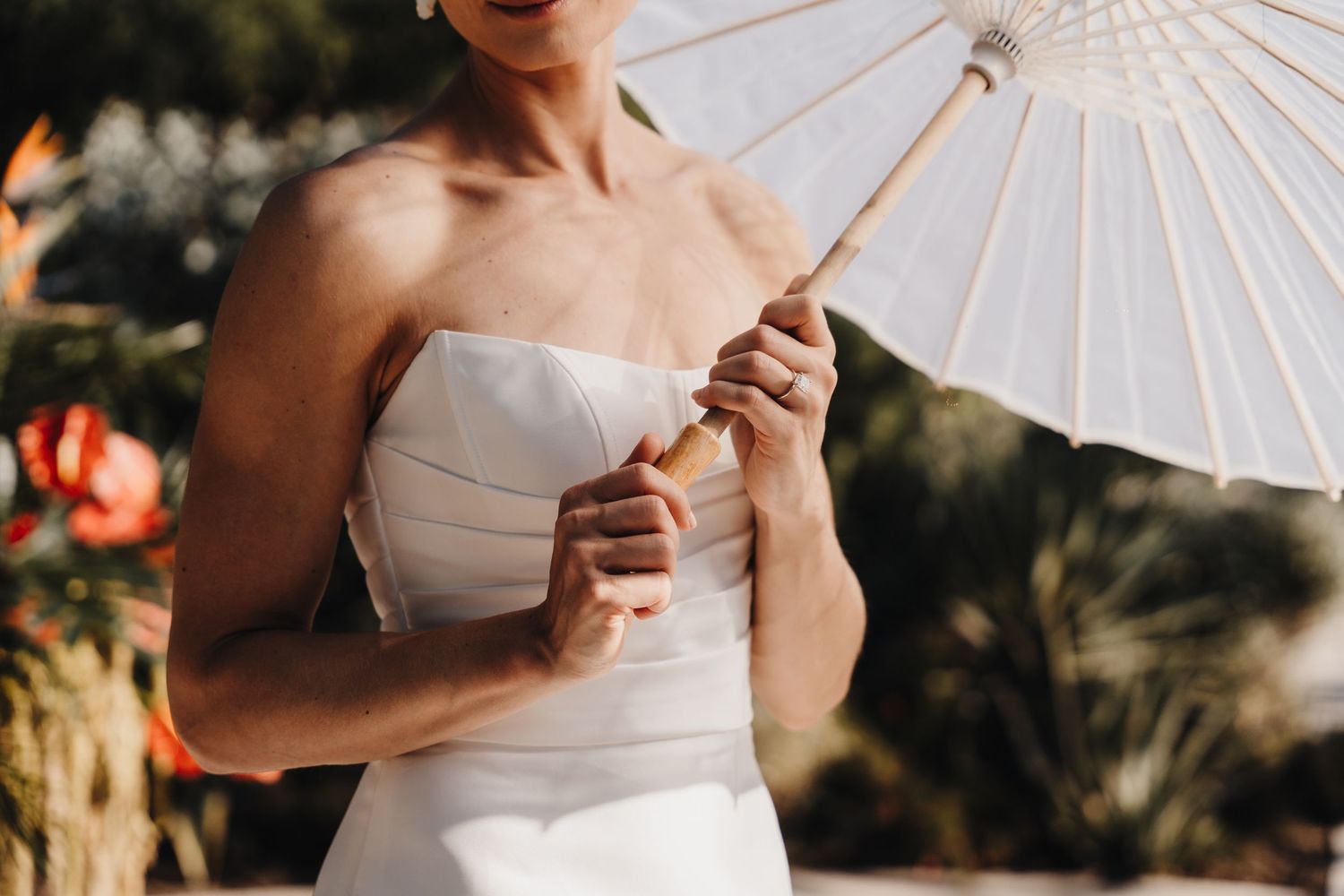 Close-up detail of a white parasol being held against bright natural sunlight.