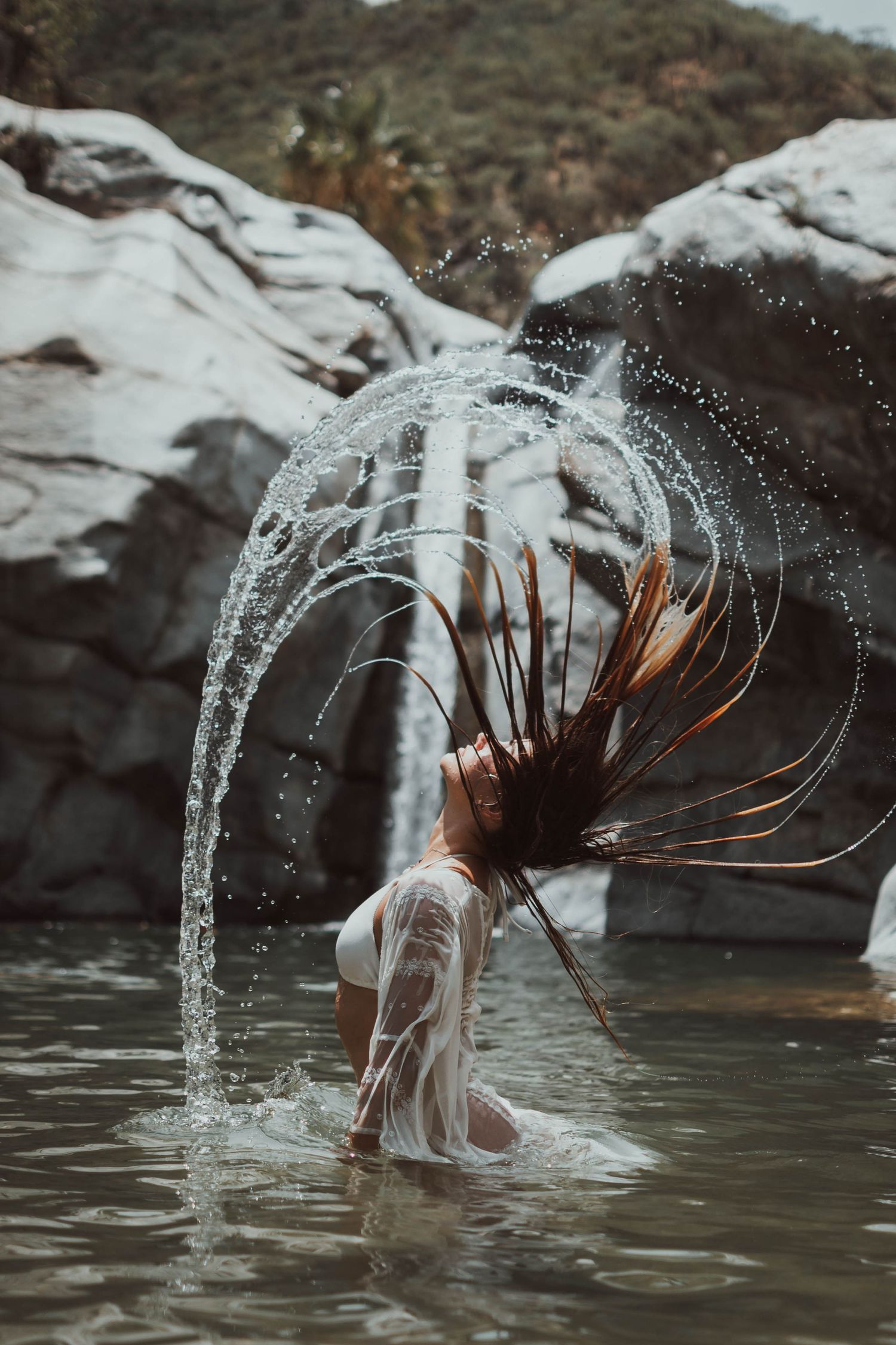 Dynamic water splash photography with dramatic lighting and rock formations.