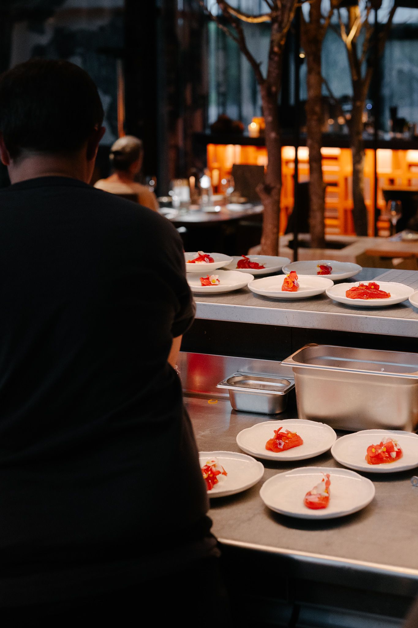 A cook plating a starter at a gastronomic restaurant
