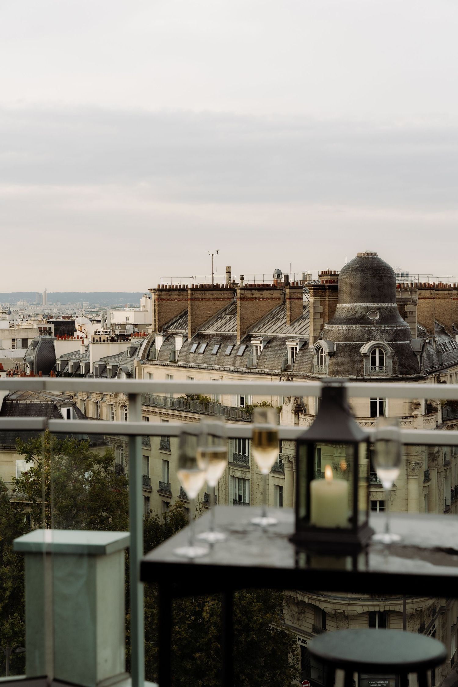 A glass of champagne on a table on the rooftop of a building in Paris