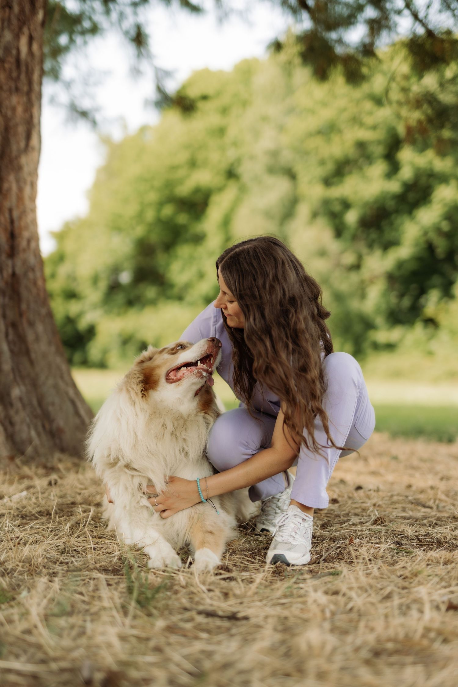 A veterinarian playing with a dog in a park