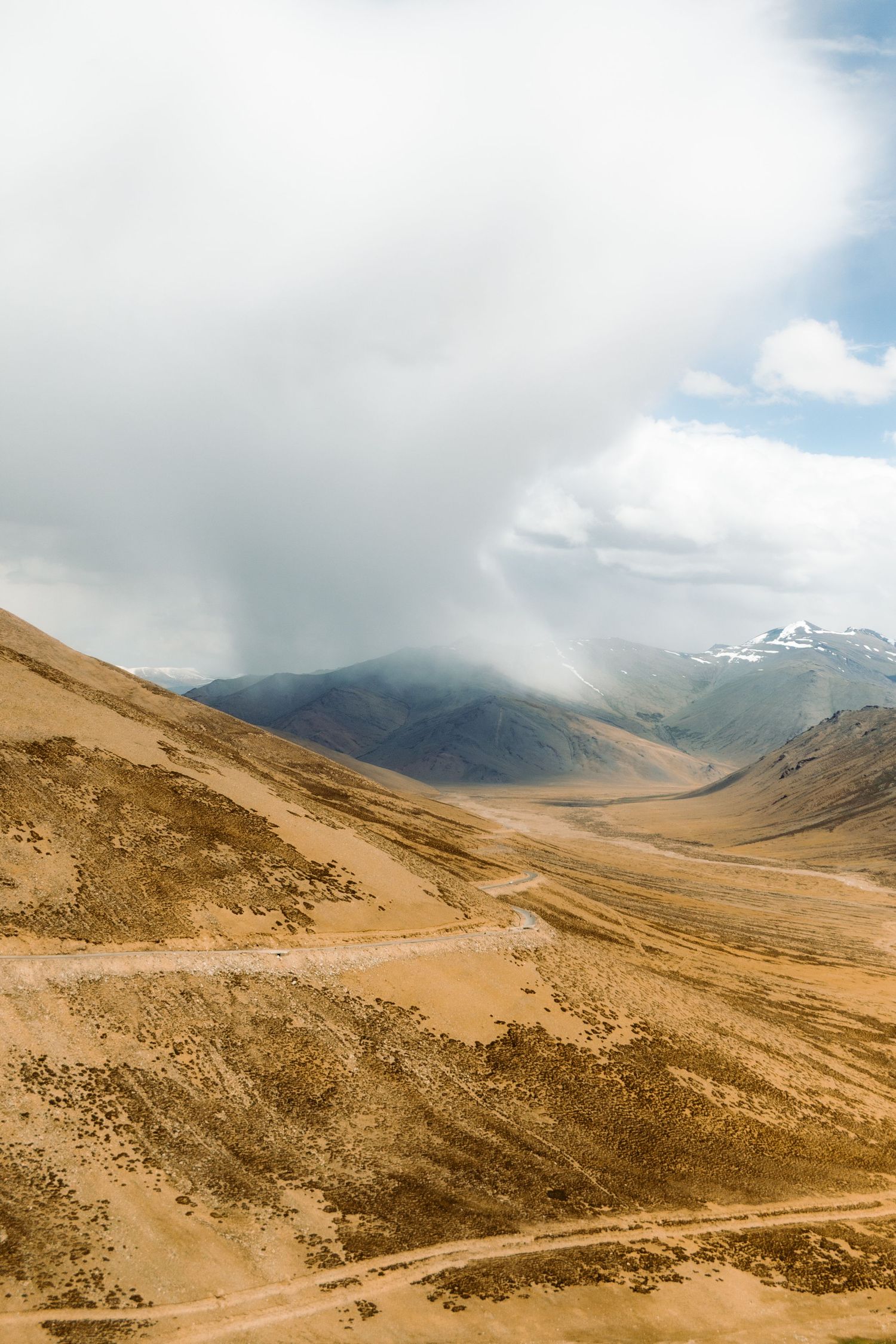 Rain is seen in the distance in the Himalayan mountains