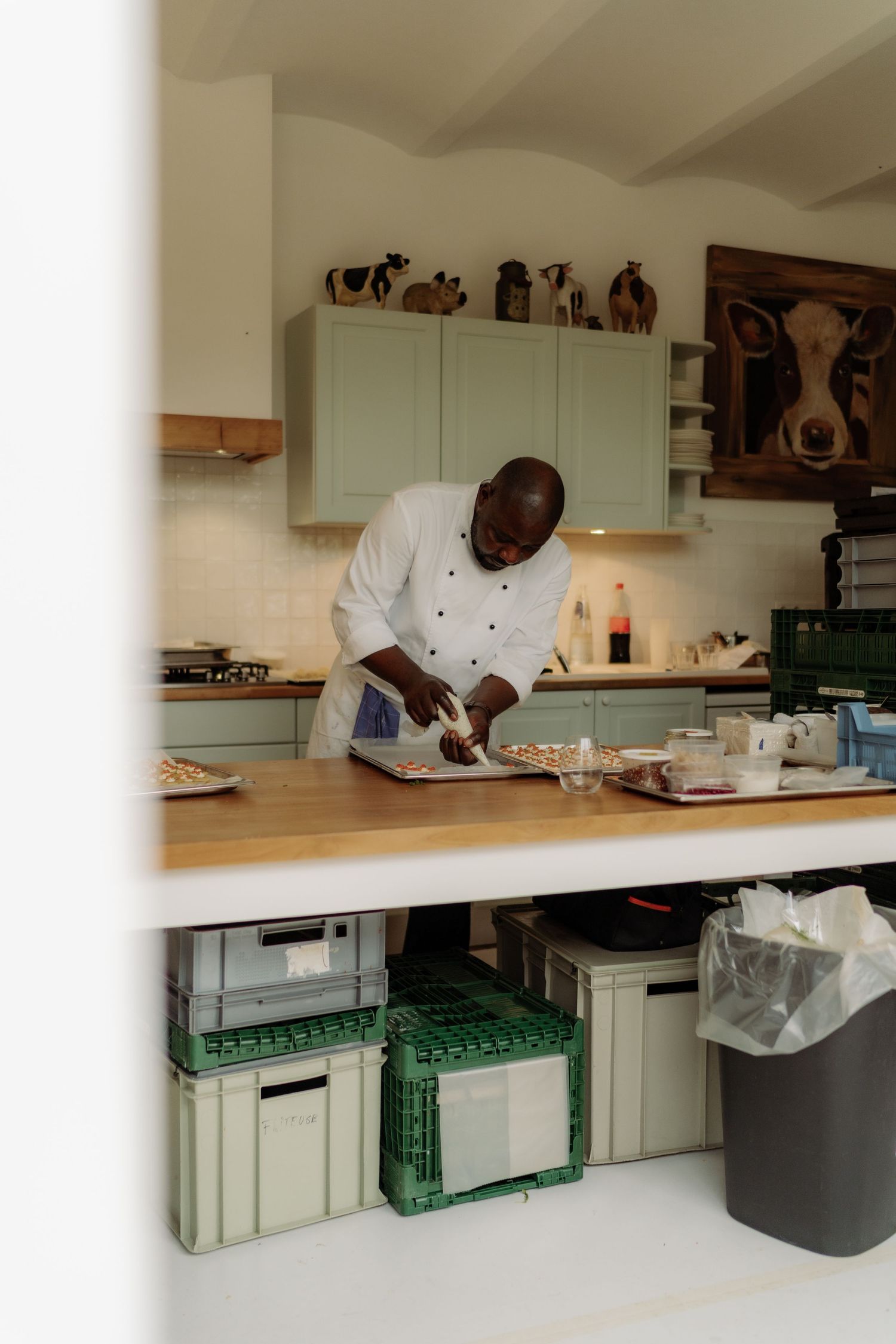 A photo of a cook preparing food for guests