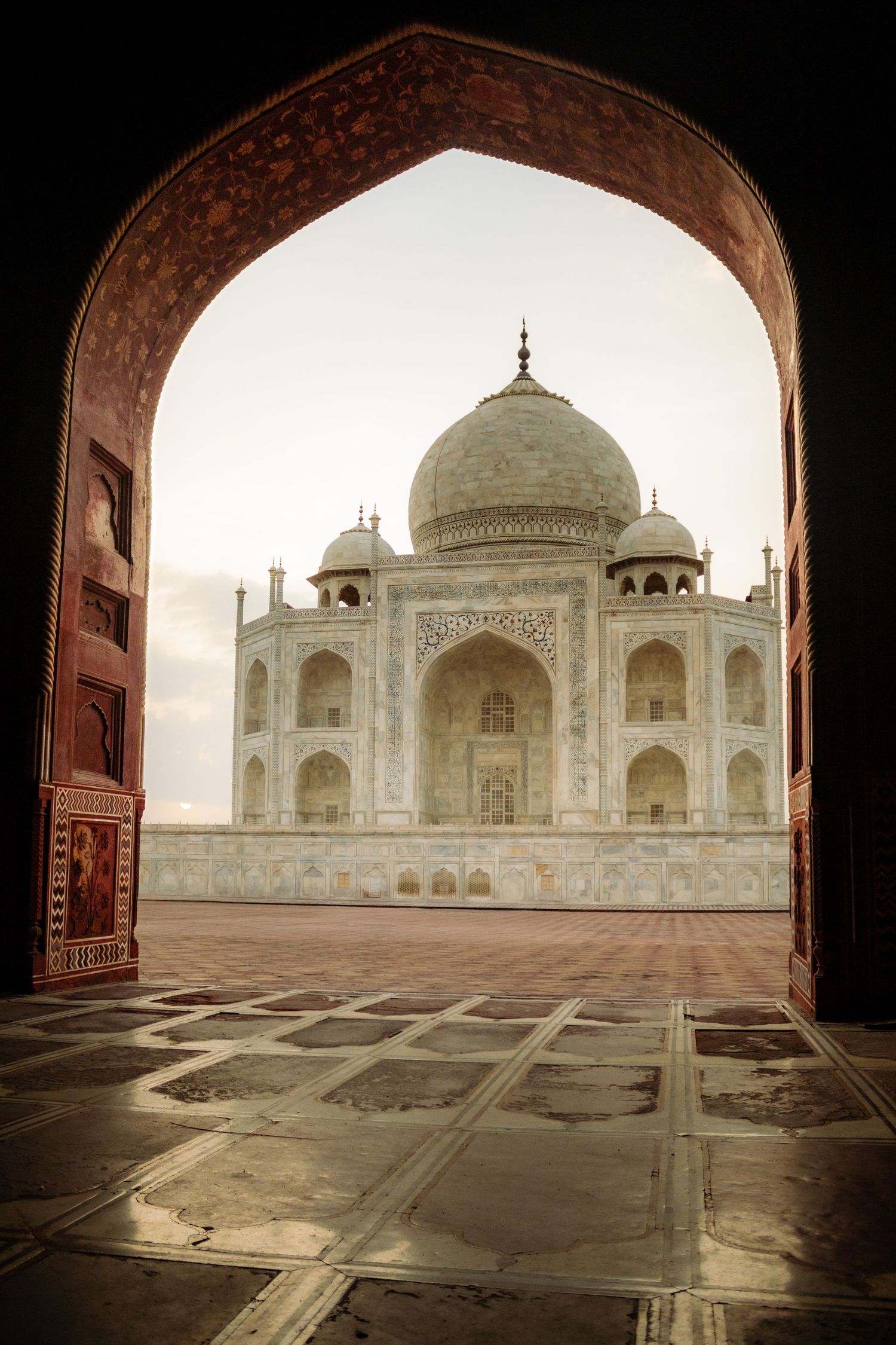 the Taj Mahal through a doorway in Agra, India