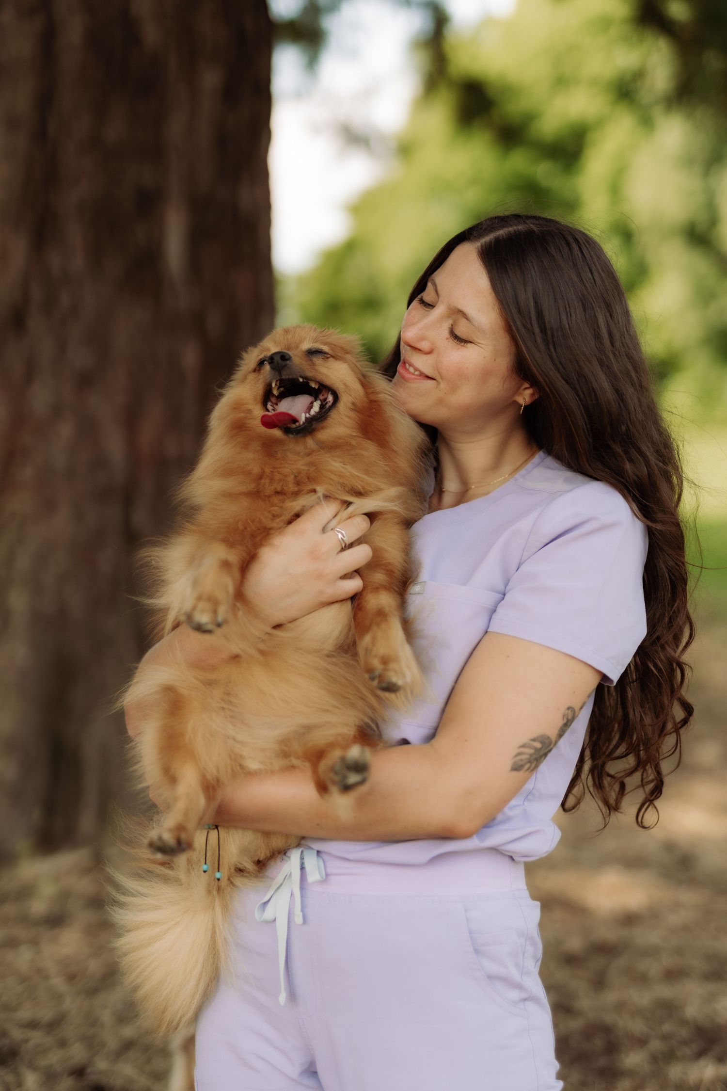 A veterinarian playing with a dog in a park