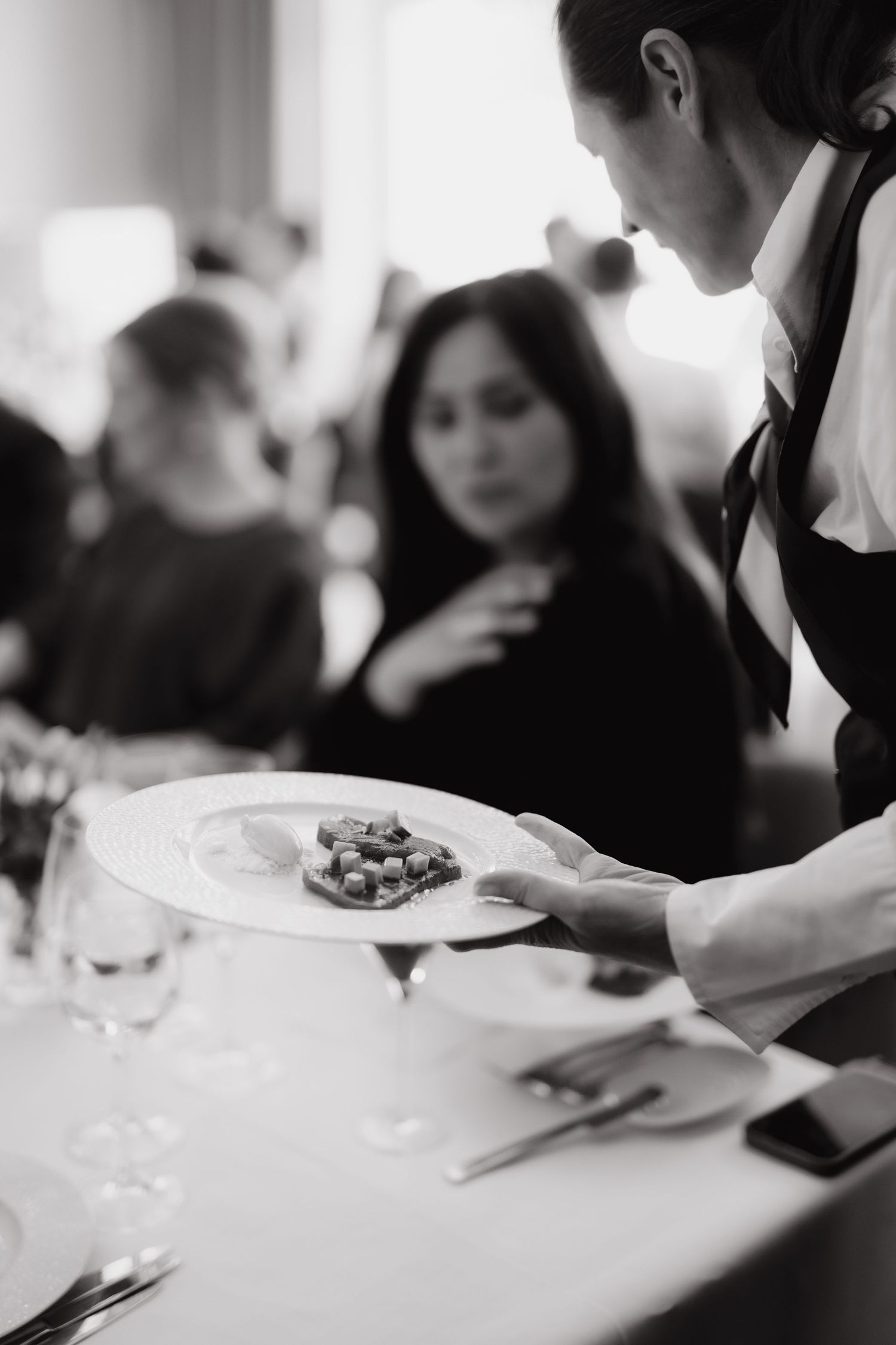 A waitress is serving the guests