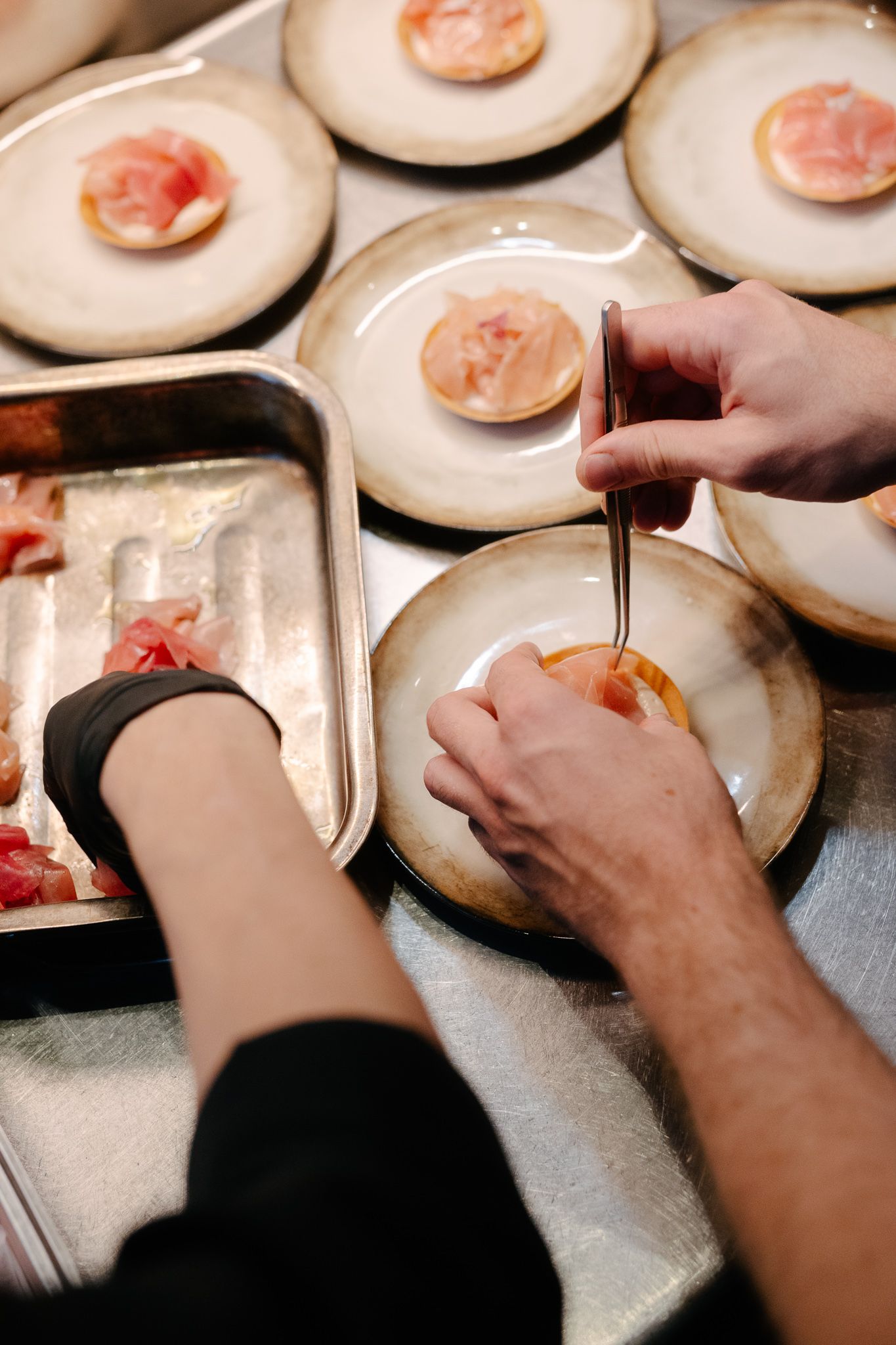 A cook plating a starter at a gastronomic restaurant
