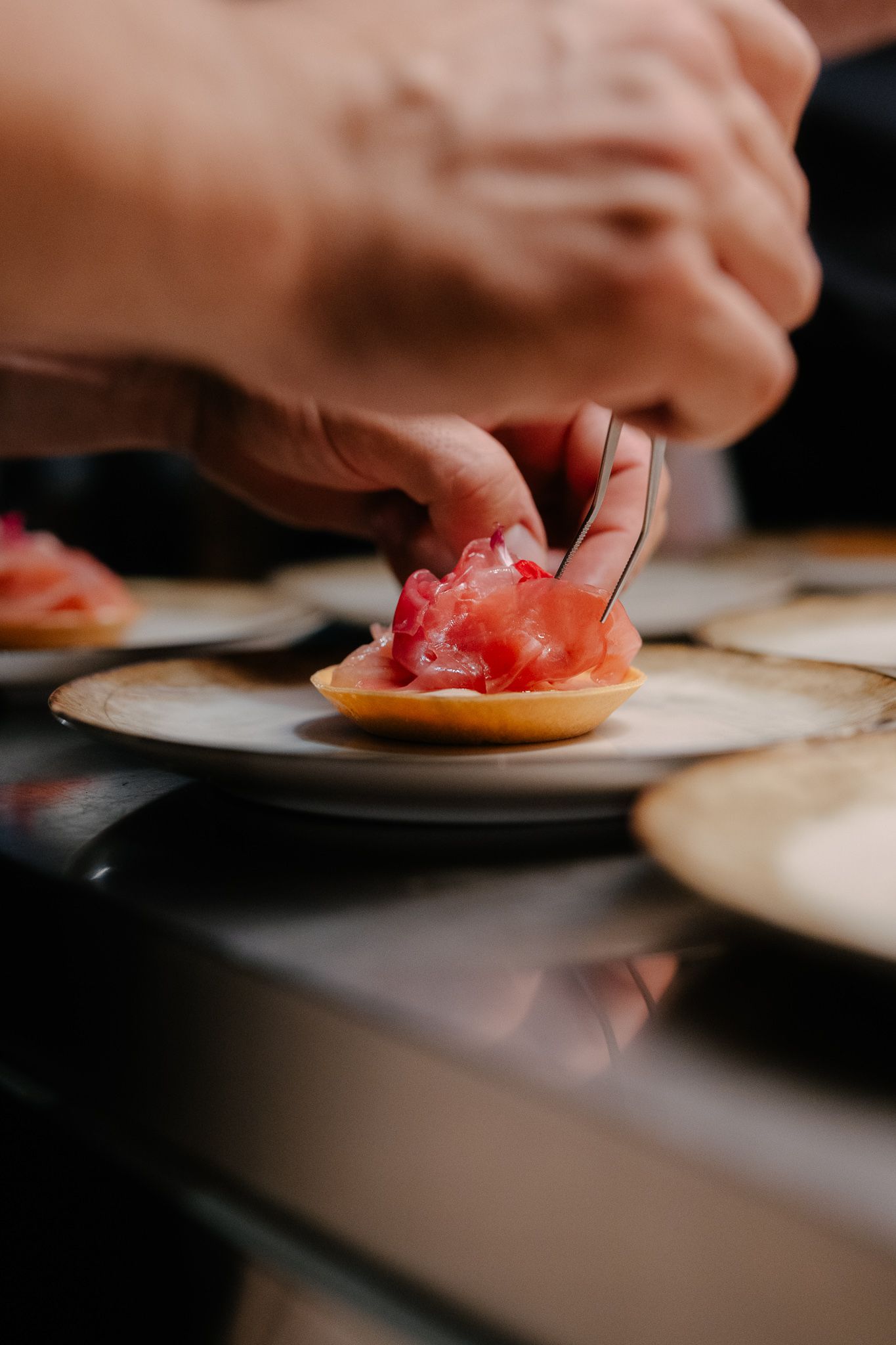 A cook plating a starter at a gastronomic restaurant