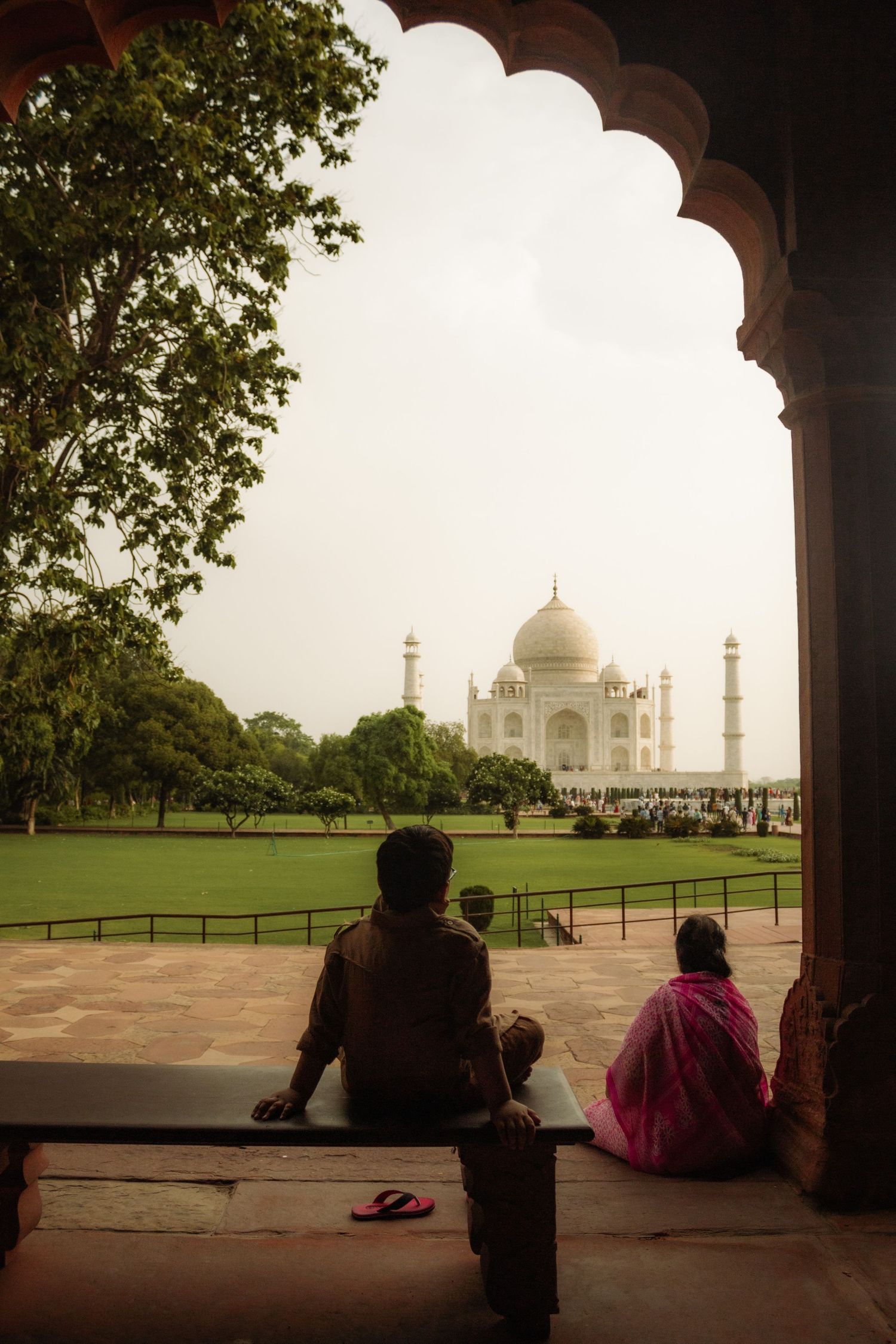 Two people look at the Taj Mahal