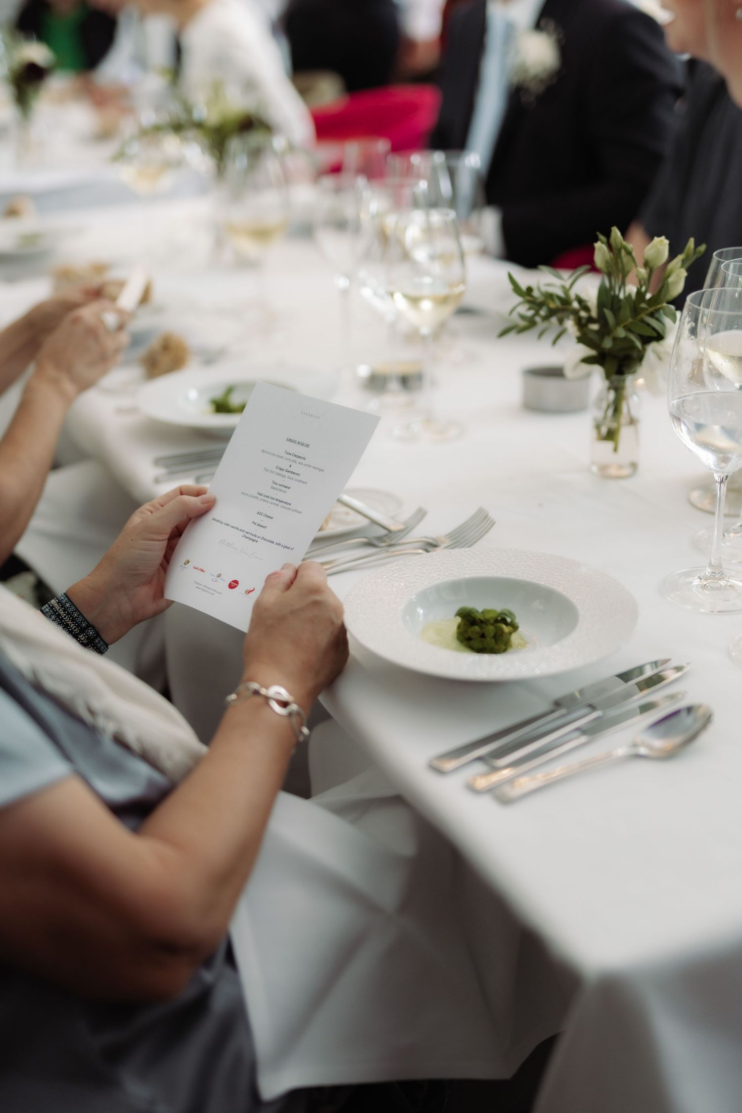 A woman is looking at the menu for the meal she is enjoying