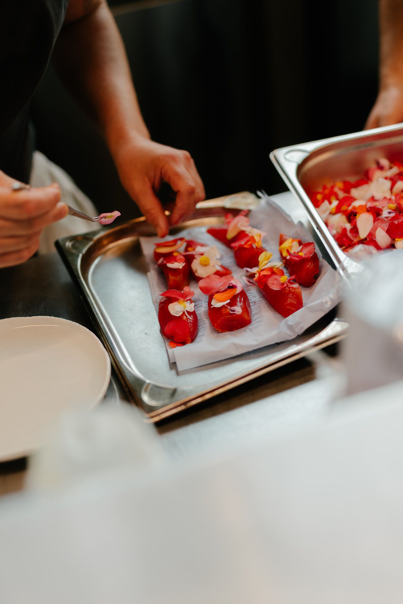 A cook plating a starter at a gastronomic restaurant