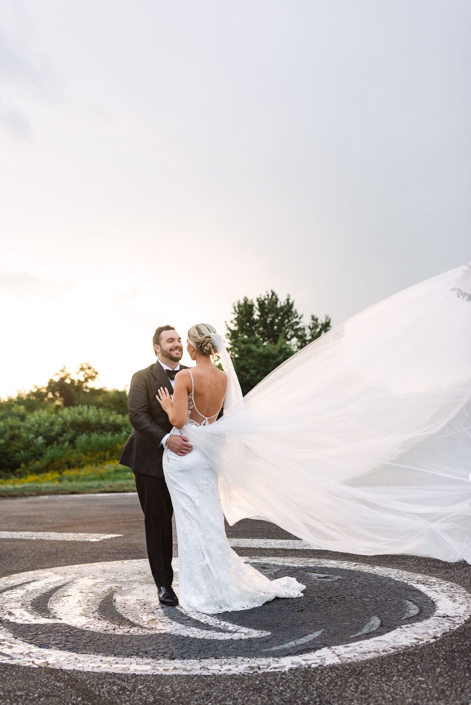 Candid bride and groom portraits on the helipad at Eagles Nest Golf Club in Toronto, photographed by a Toronto wedding photographer.