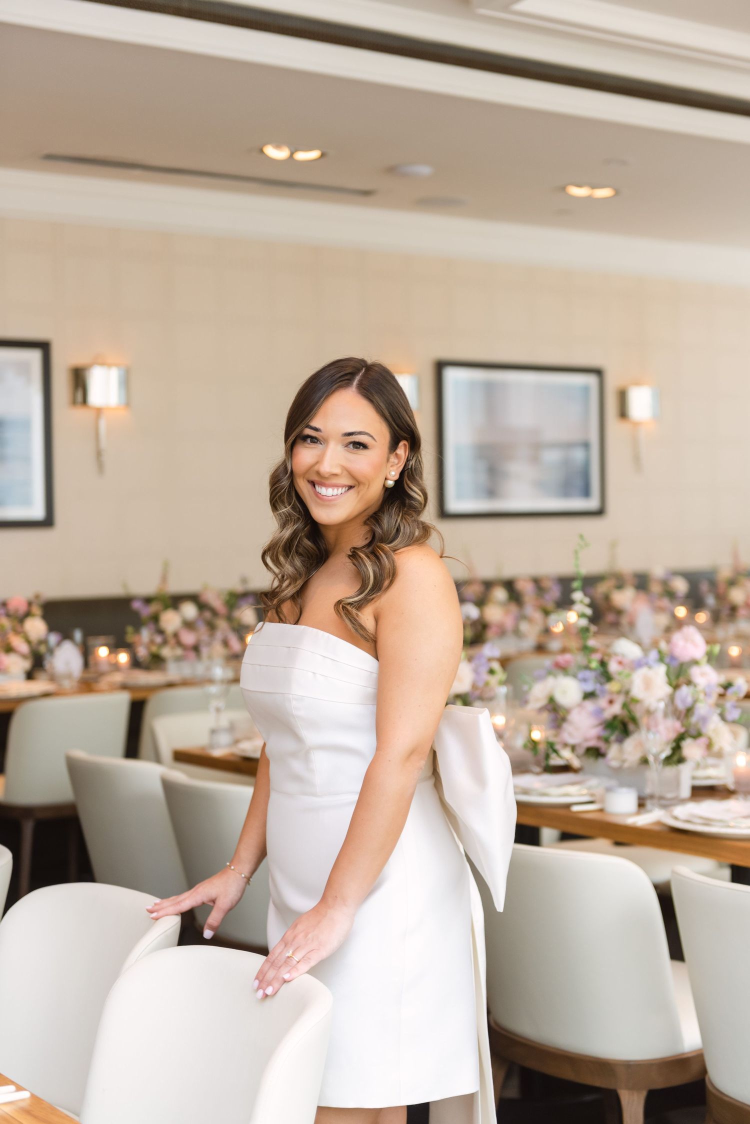 Bride-to-be standing with bridal shower room decor at The Chase in Toronto, photographed by a Toronto lifestyle and event photographer.