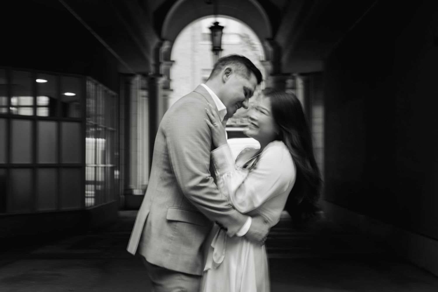 Black-and-white blurry photo of a couple during their engagement session at The Esplanade in Toronto, photographed by a wedding photographer