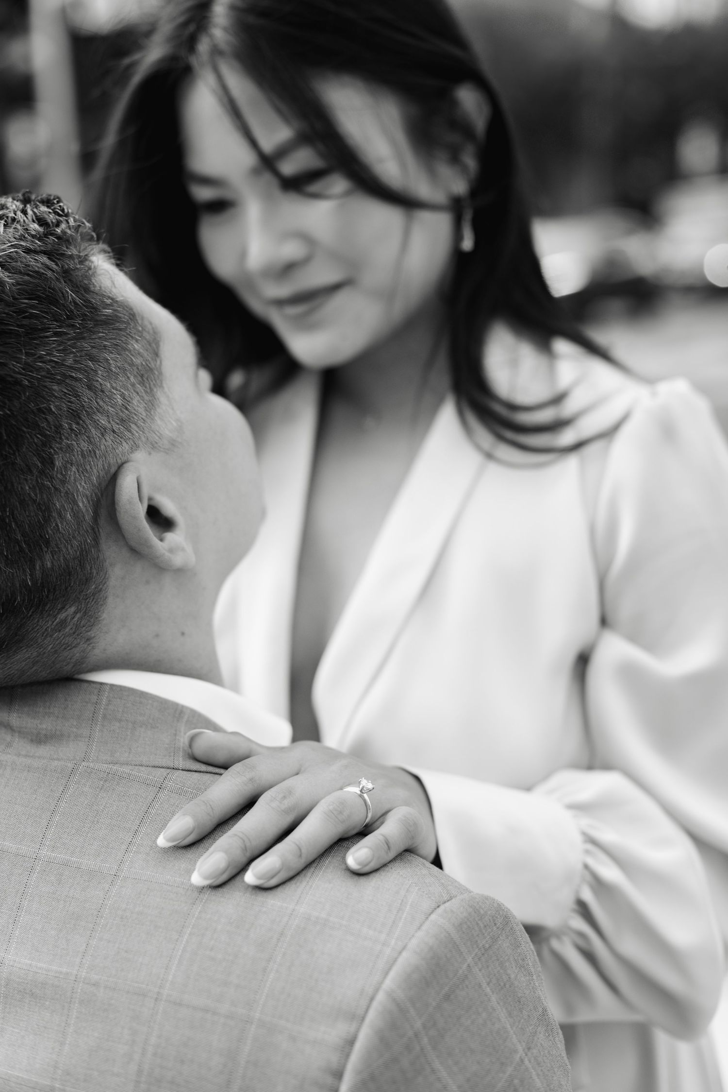 Black-and-white photo of a couple during their engagement session at The Esplanade in Toronto, photographed by a wedding photographer