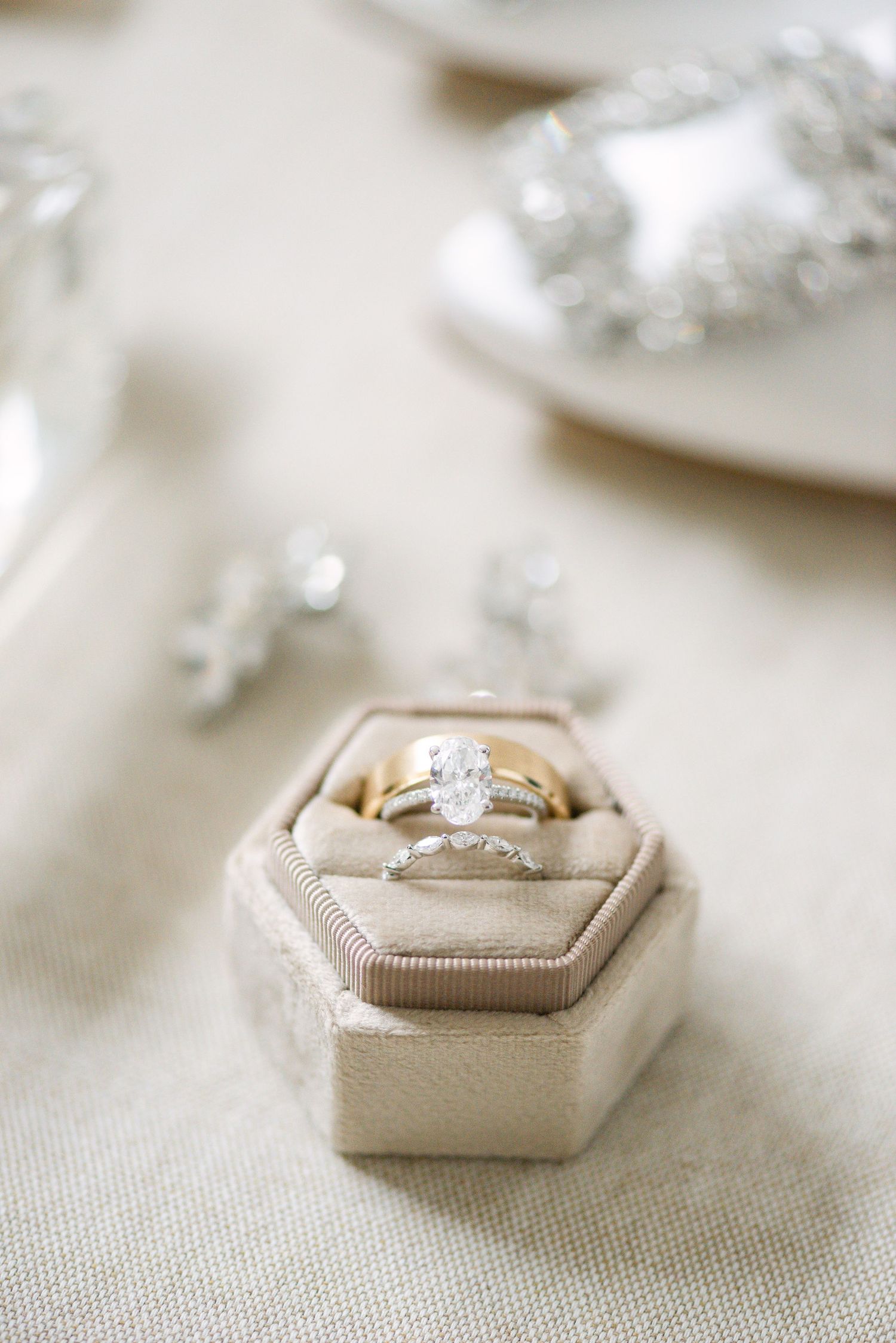 Flat lay detail of engagement ring and wedding bands in a ring box, photographed by a Toronto wedding and engagement photographer.